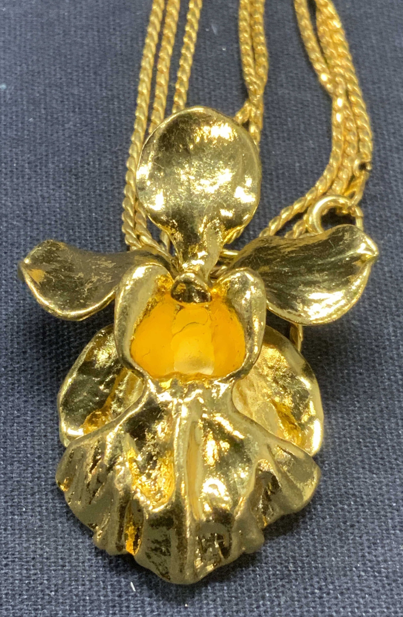 Gold Tone Orchid Pendant Necklace: Gold tone orchid pendant necklace. Total drop length approx. 17 inches. Pendant measures approx. 1.75 x 1.25 inches. Some scratching observed. Estate jewelry, costume jewelry, fashion jewelry, cocktai