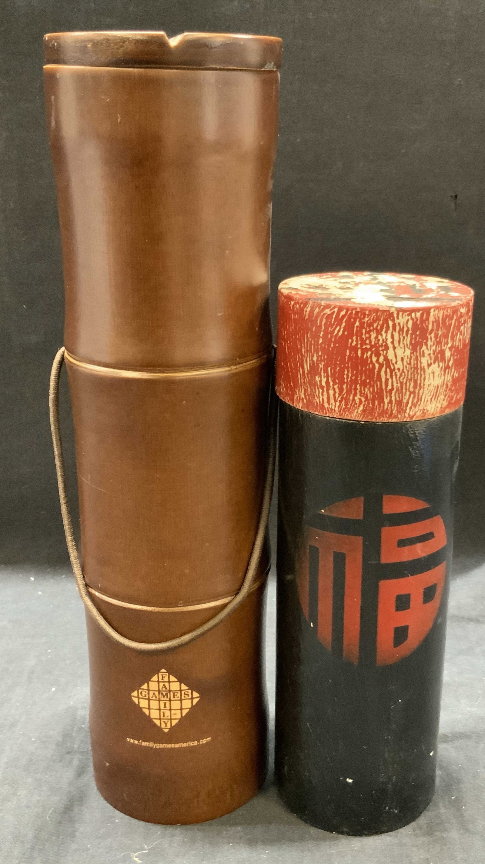 Lot 2 Chinese Fortune Sticks & Dao Game: Lot of 2 Asian style activities. 1 black lacquered tube container with Chinese fortune sticks inside with manual. Approx 7 x 2 inches. And 1 Dao stick game with manual. Comes in container that resembl