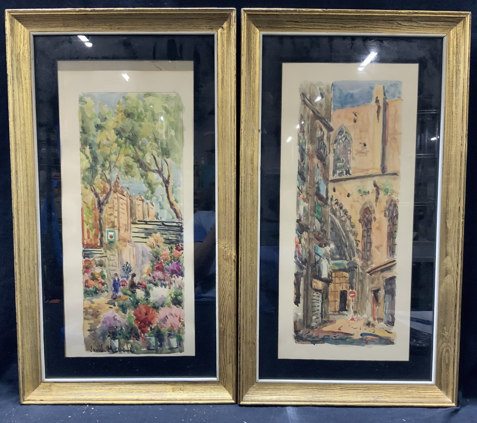 2 Sgd David Mezcade Street Scene Watercolors: Pair of watercolor paintings on paper, depicting two different street scenes, one of a city park the other of a European city street. One signed on corner Possibly reads David Mezcade. Both framed in 
