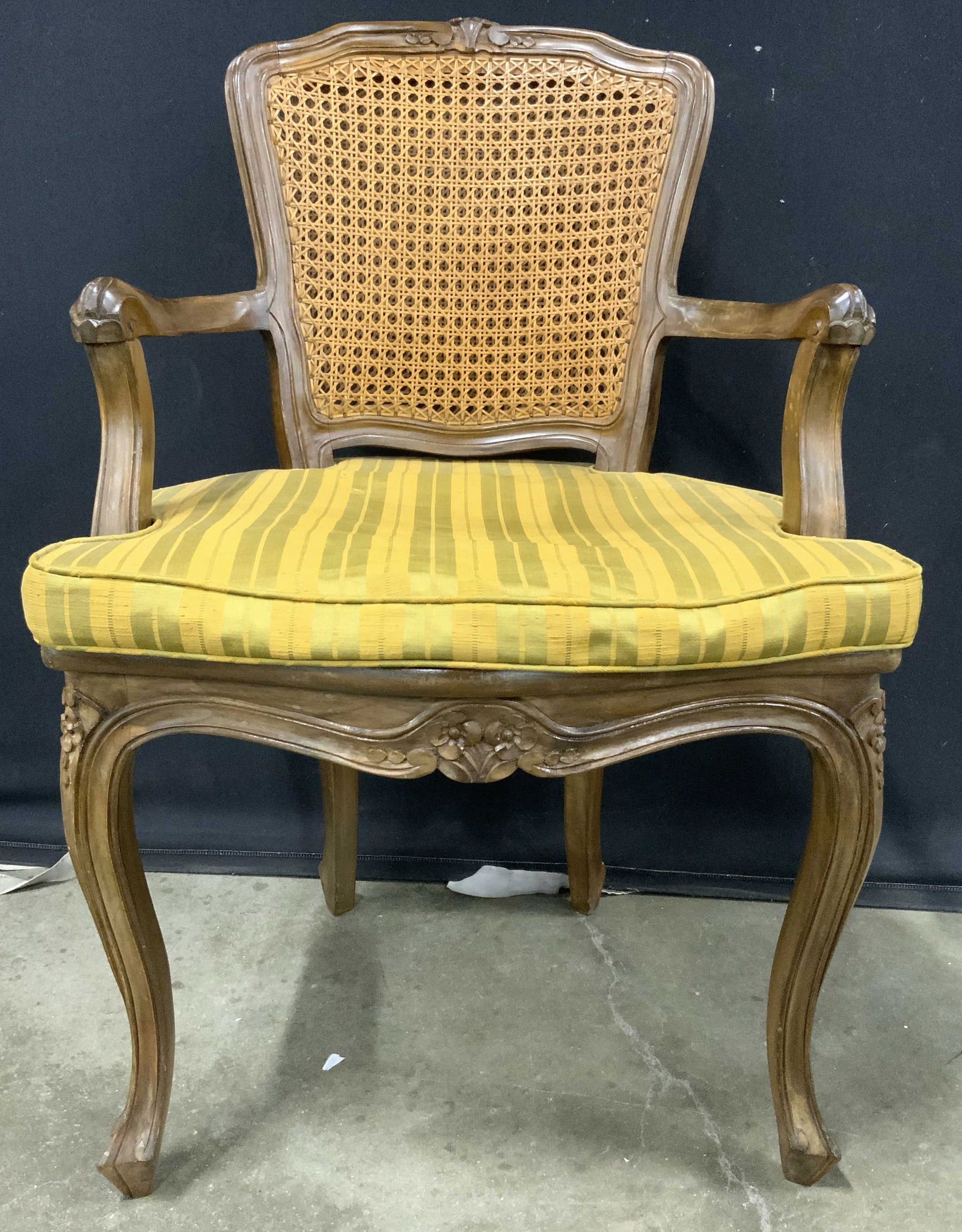 Vntg Louis XV Caned Carved Wooden End Chair: Vintage Wooden End chair with Louis XV styling. Chair includes chartreuse & golden rod striped seat cushion. Piece has double caned backrest. Chair has carved wooden frame with floral & leaf detail. C