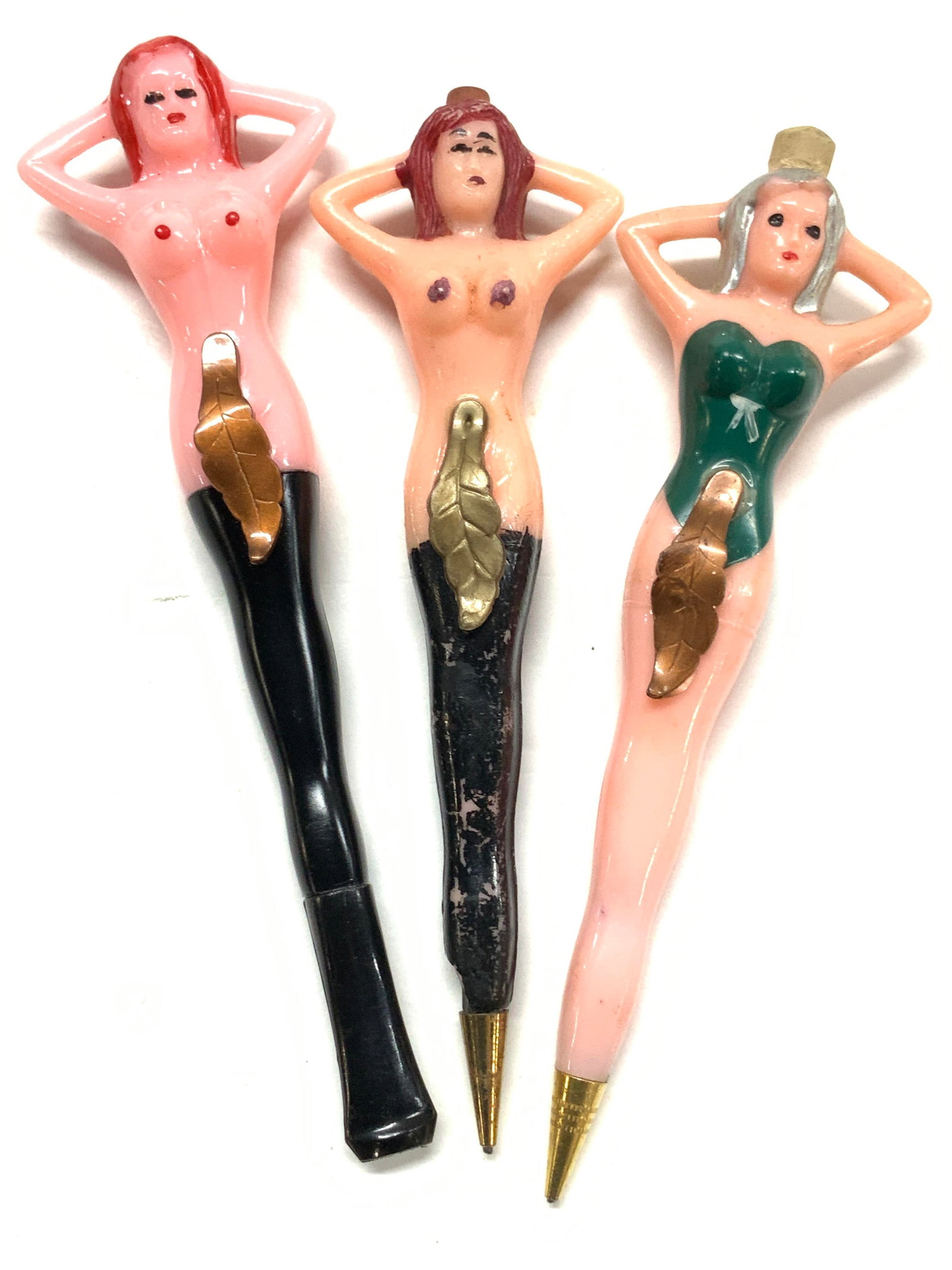 3 Collect Nude Pin Up Pencils & Cigarette Holder: Fishlove& Co Mid century Nude pin up girl Figural pencils and a cigarette holder. Plastic based collectibles c. 1950s. 2 are pencils . Both with a fig leaf, one nude with red hair ( has a chip near to