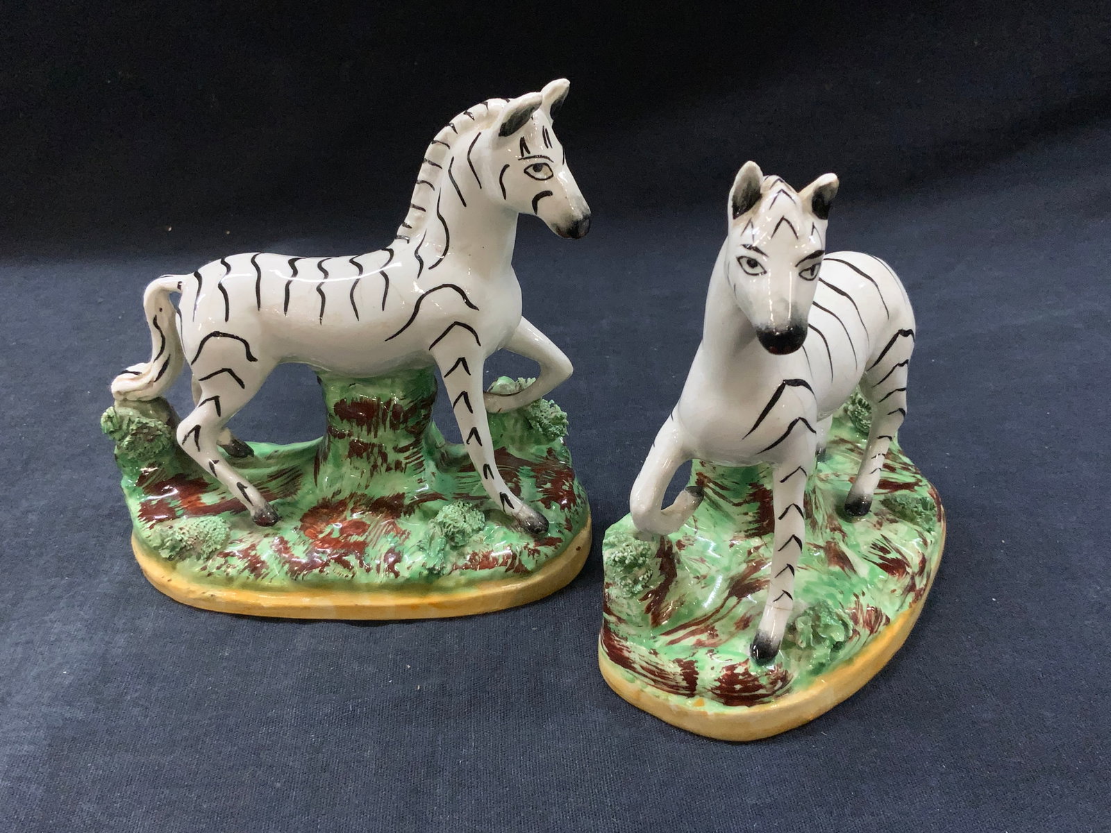 Pr Old Staffordshire Ware Zebra Figurals, England: Pair of antique porcelain Old Staffordshire Ware zebra hand-painted figurines. Made in England. Stamp on underside reads Old Staffordshire Ware England. Measures approximately 4.75 in height. Base mea