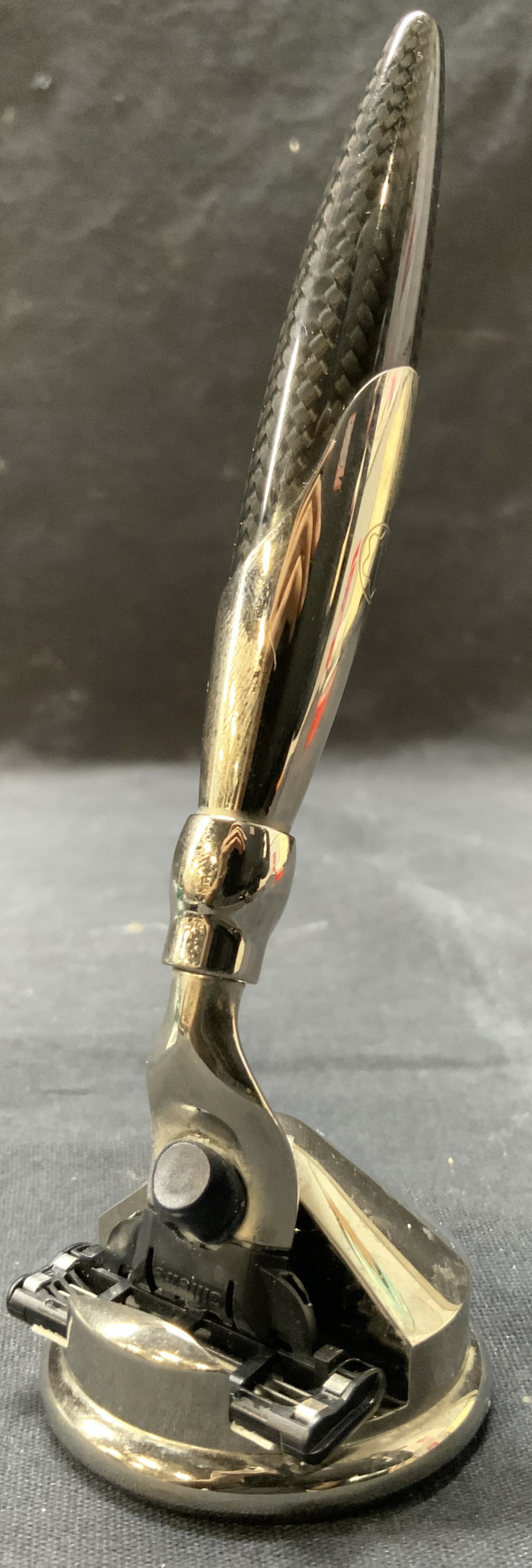 MONTBLANC Carbon Fiber Shave Razor & Heads: Shave razor is trademarked MONTBLANC. Shaver is carbon fiber & chrome. Lot includes razor 4 razor heads & weighted metal stand. Razor with head measures approximately 5.75 inches long 1.5 inches wide.