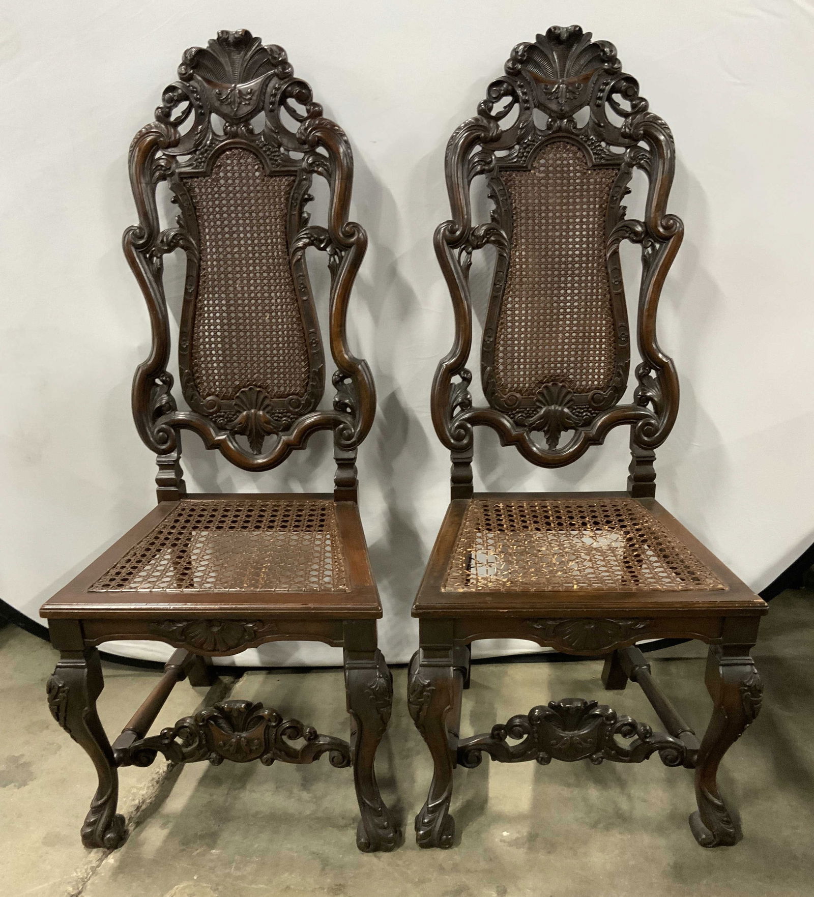 Pr Antq Jacobean Renaissance Revival Carved Wood Chairs: Lot includes 2 chairs. Each appeared to be Antique Jacobean Renaissance Revival. Lot includes 2 chairs. Each are brown toned & wooden. Chairs each have caned seats & backrests. Each have scrolled deta