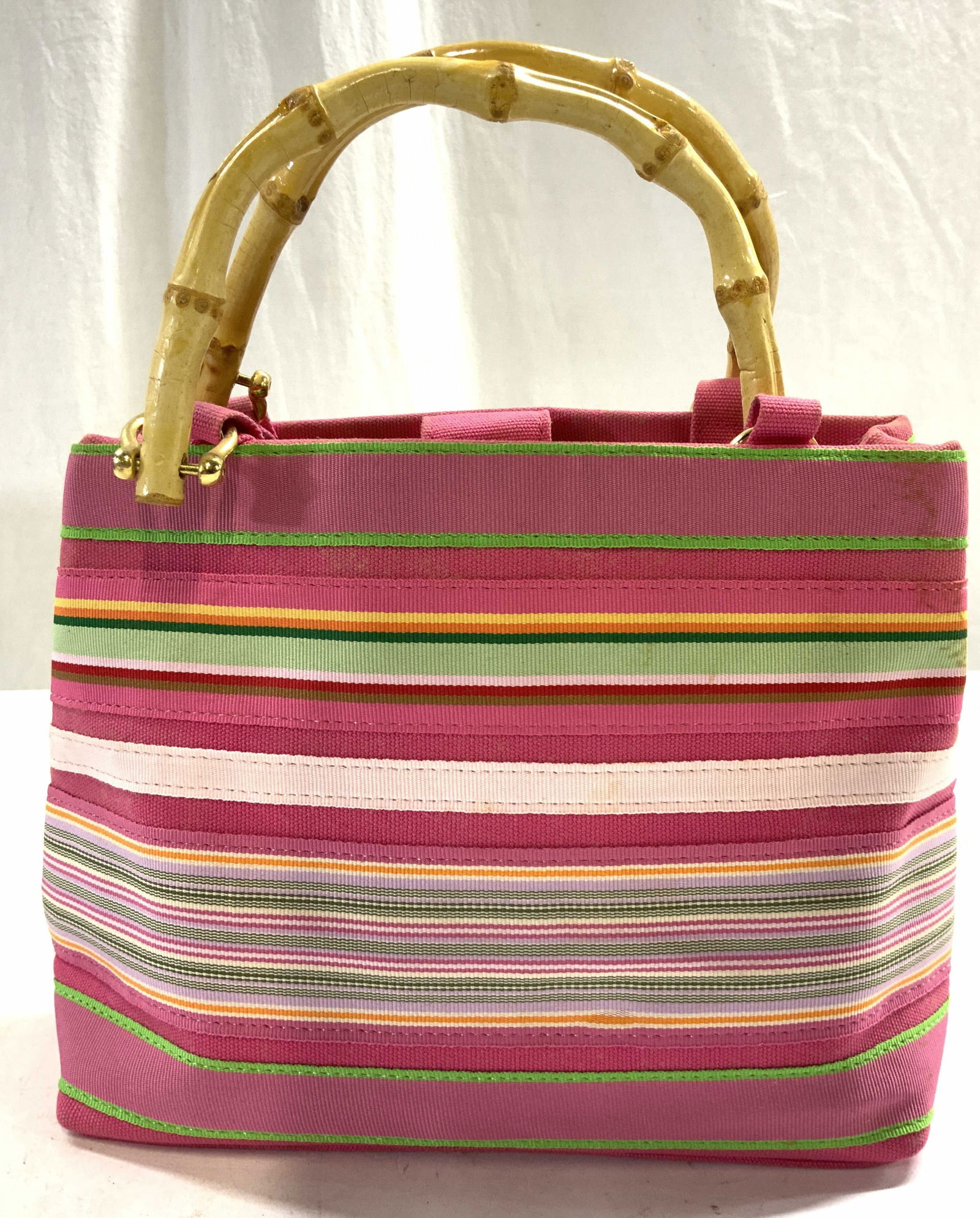 TIANNL Ribbon Purse W Bamboo Style Handles: Interior tag reads TIANNL. Interior is chartreuse toned with 1 zippered pocket. Exterior multi toned horizontal stripe detail. Purse has snap button clasp. Purse measures approximately 11.5 inches tal