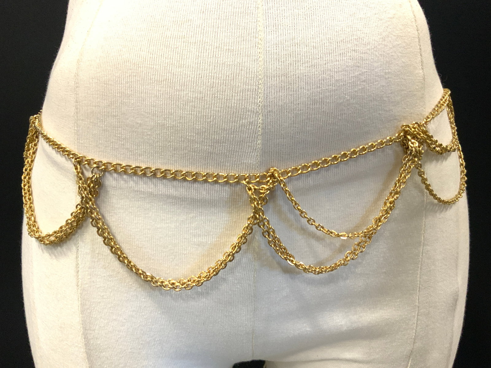 One Pesewa Gold Tn Body Chain: Marked on charm, one Pesewa, Ghana peace and Justice. Gold toned body chain. Approx 35 inches long. Moderate wearing to chain with scratches observed, Gold toned chain, body chain. Belly dancing chain