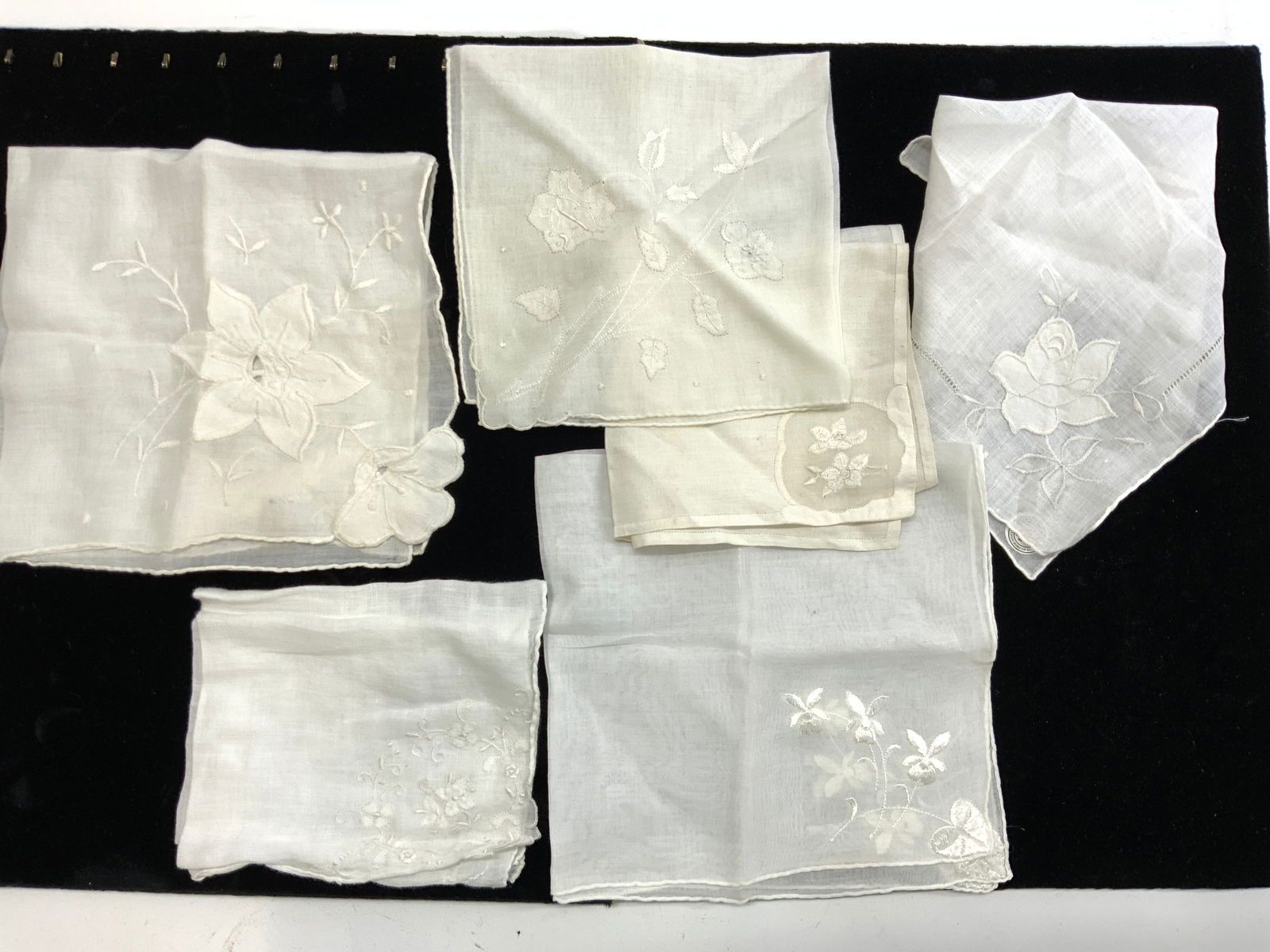 6 Vintage White Linen Embroidered Hankies: Soft hand rolled linen and cotton hankies, Applique and embroidered hankies. All white. 1 never used hankie made in Hong Kong with original sticker label. All have flower designs, white on white. Soft