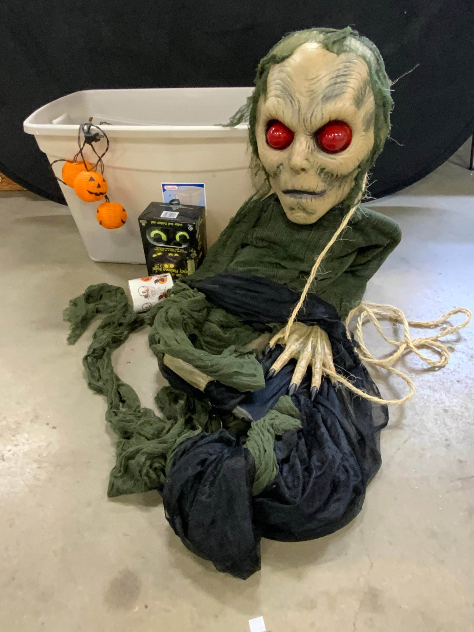Group Lot Halloween Decorations: A group lot of Halloween decorations. Lot includes pumpkin lights, flashing skull necklace, a large ghoul figure, Peep N Peepers, and more. Peep N Peepers Box measures approx. 9L x 6W in. Items in the