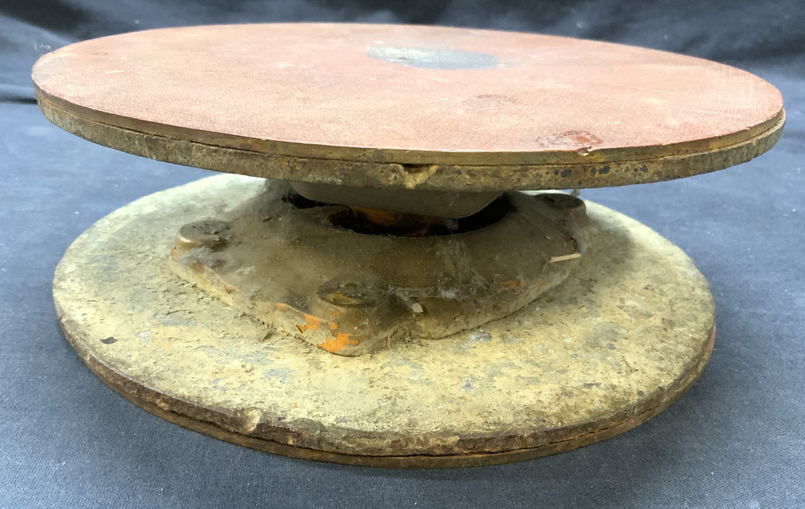 Vintage Cast Iron & Cement Pottery Wheel: Pottery wheel is vintage. Piece appears to be cast iron and cement. Top of piece is sienna toned. Pottery wheel is significantly weighted. Piece measures approximately 8.75 inches diameter 3 inches ta