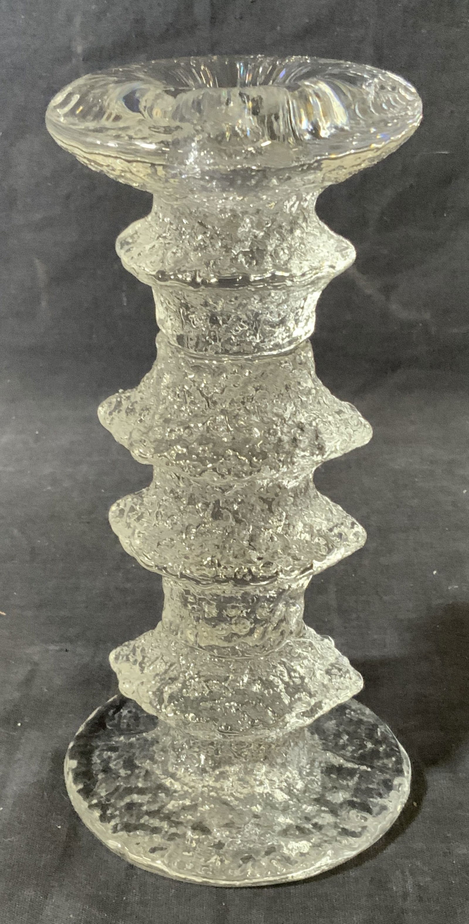 Clear Art Glass Candle Stick Holder: Clear art Glass candlestick holder, piece measures 7 inches at tallest point, piece is made of a thick walled glass with a textured and ribbed exterior, no apparent inscriptions or markings, Glass, ar