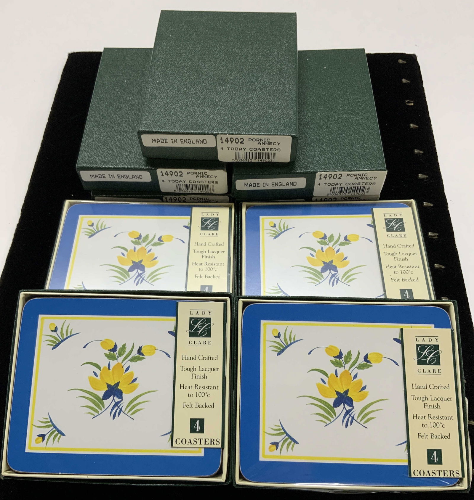 36 Lady Clare Hand Crafted Lacquer Coasters, NIB: Lady Clare Pornic Annecy flower motif coasters , new in boxes. 4 coasters to a box, 9 boxes total. Blue, white, and yellow lacquered coasters , hand crafted with a felt backside. Measure 4.25 x 3.5 in