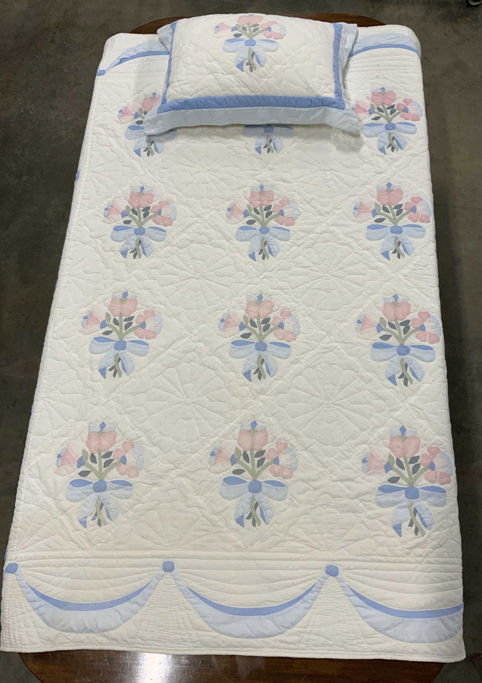 Cotton Twin Sz Quilt & Sham w Hand Applique: Twin size Quilt Coverlet with matching sham. Hand applique flowers and sweeping blue bow design as a border. White, baby blue, and pink are the main colors. Quilt measure 66.5 x 83.5 in. Standard Sham