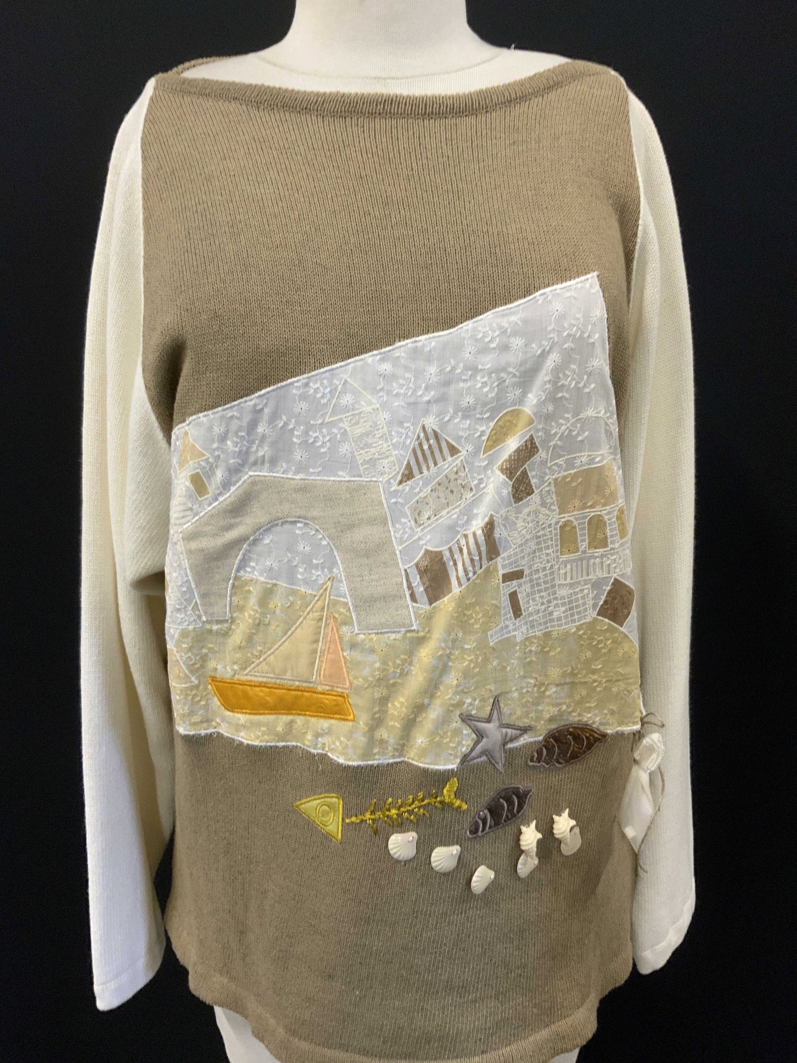 Mademoiselle Sweater w Nautical Applique & Access.: Designer Mademoiselle Knit sweater. Cream sleeve sand mocha front and back. Multi textile Applique and accessories on the frontside, nautical and beachcomber designs and accessories of sequin shells a