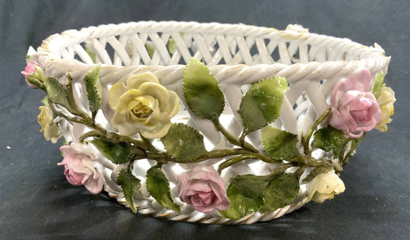 Von Schierholz Antique Porcelain Basket: Underside has VON SCHIERHOLZ trademark. Basket is white toned a porcelain with multi toned floral & leaf structures & detail. Rim has gilt areas. Piece measures approximately 9 inches diameter 3.25 in