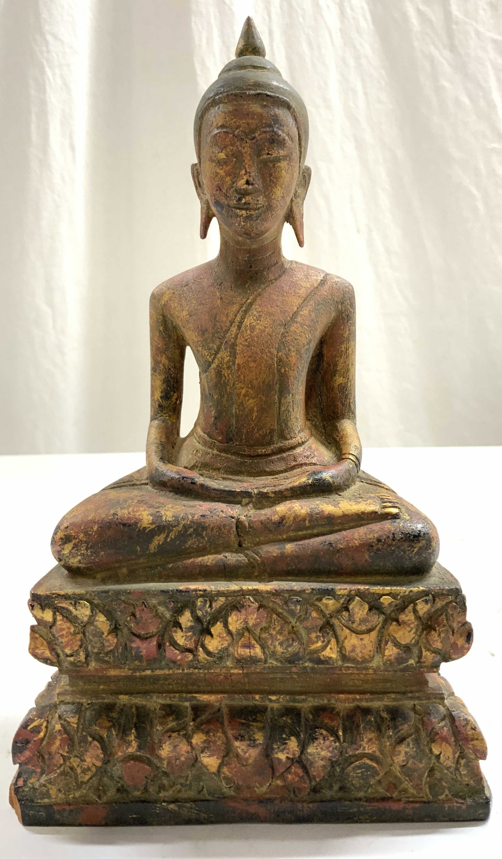 Vintage Gilt Wood Buddha Figure: Buddha figure is vintage. Piece is gilt wood. Depicts seated Buddha figure. Piece has red black and gold tones. Figure measures approximately 9 inches tall 5 inches wide 3.5 inches deep. Buddha, Buddh