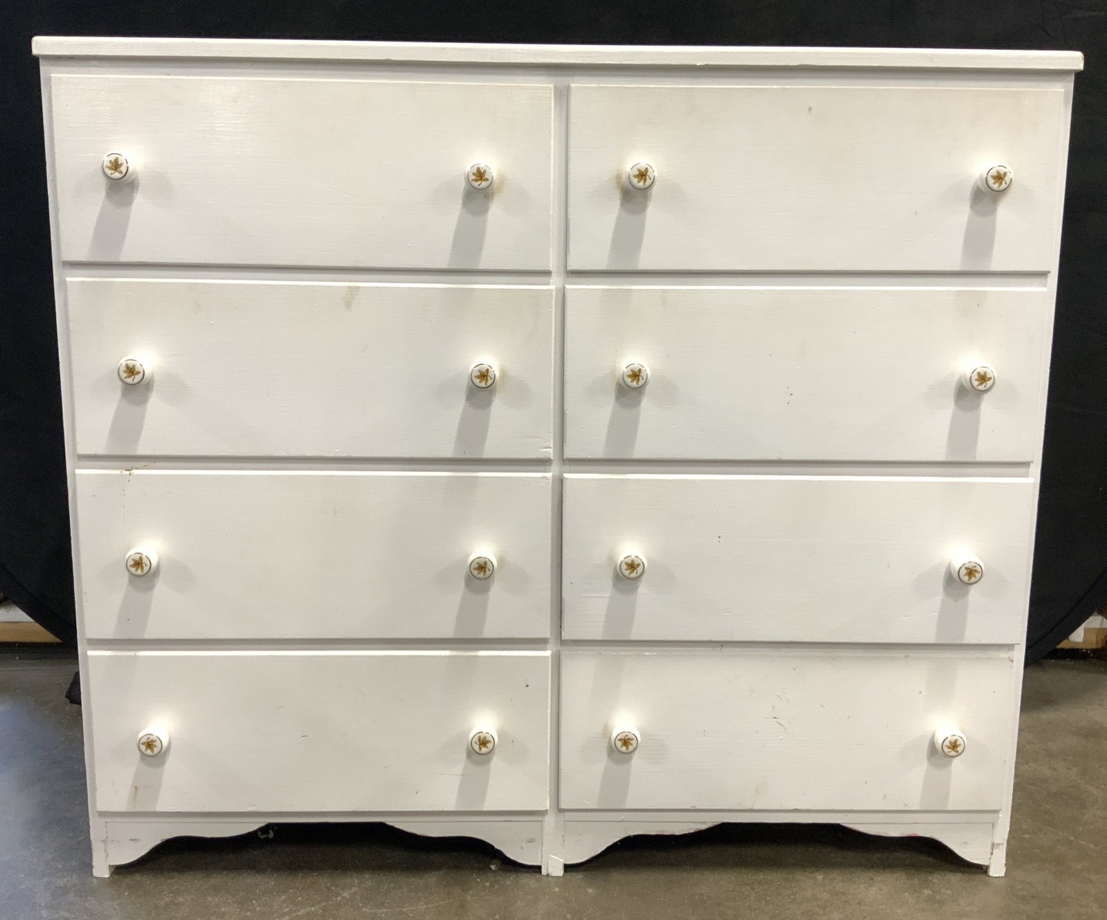 Vntg Wood 8 Drawer Dresser Chest Of Drawers White: Dresser is white toned and Wooden. Piece has 8 drawers, each with double knob form drawer pulls with leaf & gilt detail. Chest measures approximately 36 inches tall 42 inches wide 16 inches deep. Ches