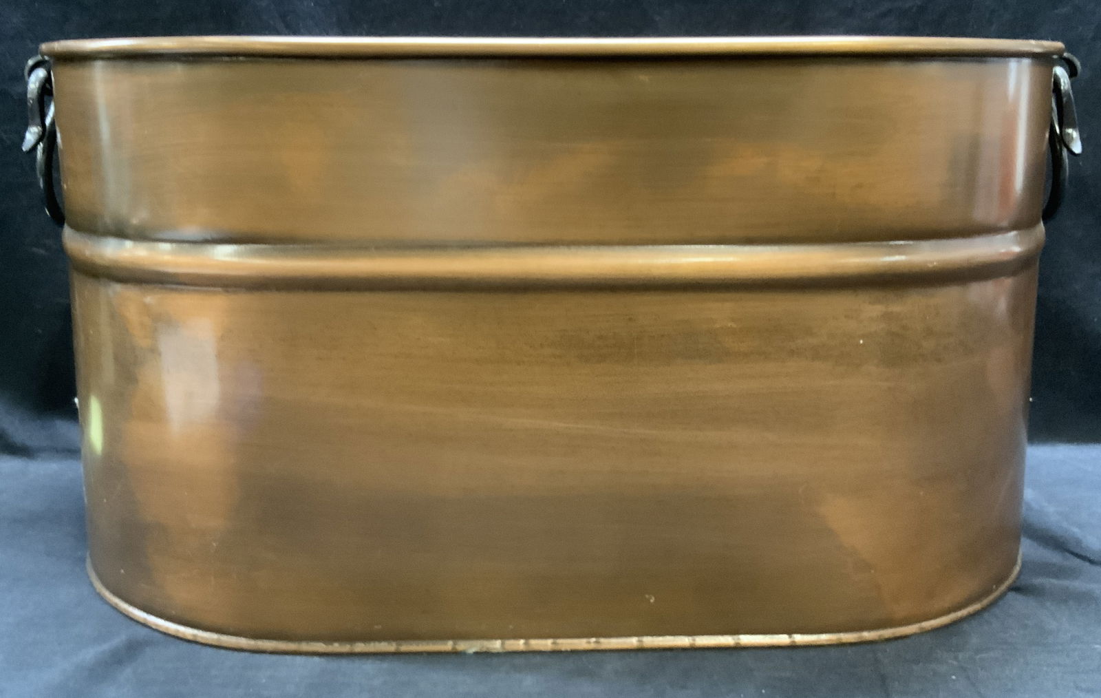 Copper Toned Wash Pot, Turkey: A copper finished wash pot. Possibly copper, possibly copper finished. Handles to either side. Measures approx. 21.5W x 11.5H in. Surface wear consistent with age, use, and exposure. Some discoloratio