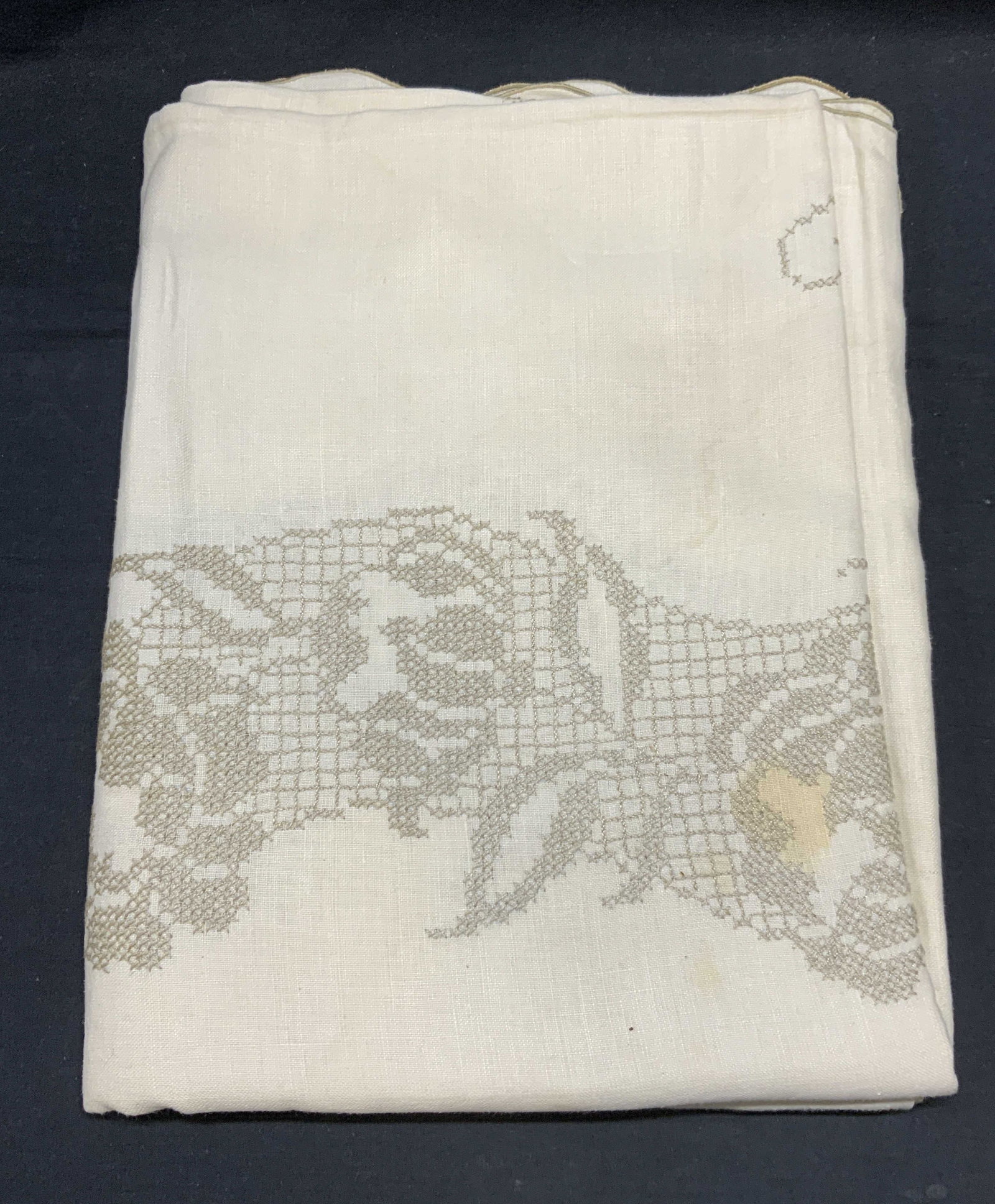 Vintage White & Tan Embroidered Tablecloth: Vintage white and tan toned tablecloth with embroidered floral scroll detail. Material feels like cotton. Measures approx. 100 inches long. Wear to material and blemishes observed. Tablecloth, white t