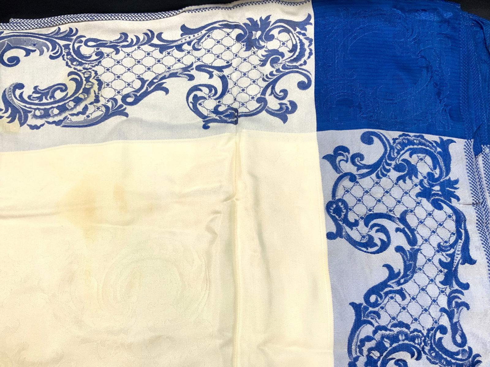 Vntg Blue Scroll Patterned Cotton Tablecloth: Approx 80 x 60 inches Blue boarders and off white center tablecloth, adorn with French style scroll designs throughout all areas, possibly made of cotton Evident blemishes to center and wearing to fab