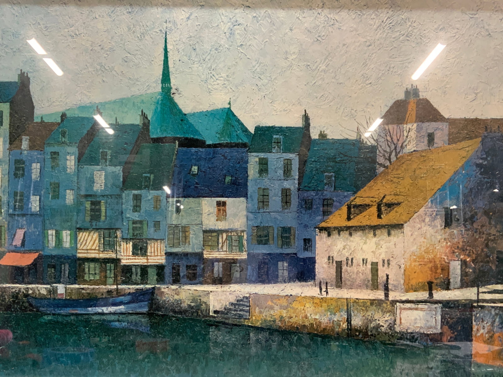 Nayreda Coastal Town Lithograph: Marked Nayreda on corner. Depicts a coastal town with a canal off the street with blue and green houses. Framed in a silver toned metal frame. Approx 2ft x 3ft window measures 23.5 x 35.5 inches Minor