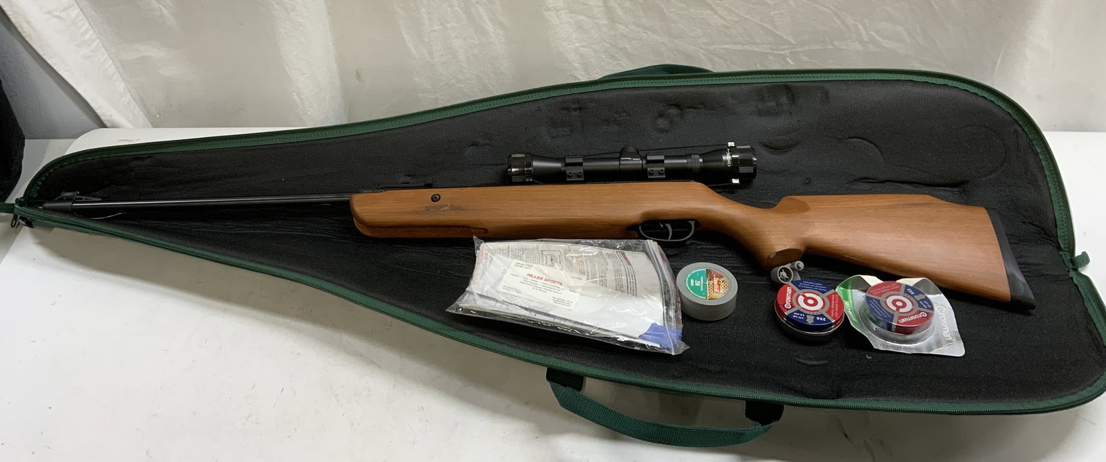 Crosman Quest 1000x C1K77X BB Gun: Crosman Quest 1000x model number C1K77X BB air rifle gun. Includes pellets and carrying case. Measures approx. 45 inches long. Piece has weight. Some surface wear including scratching observed. Not te