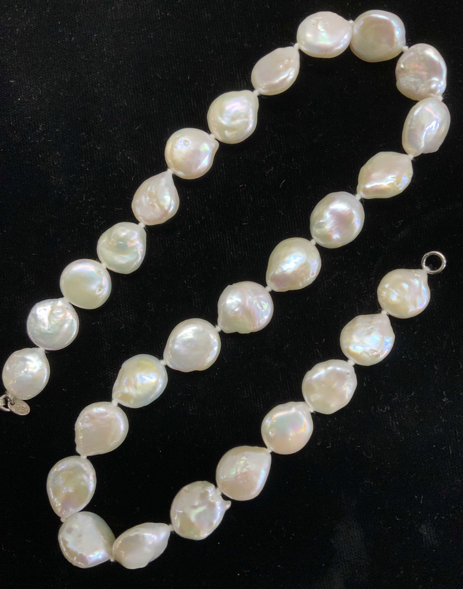 GSJ Coin Pearl Choker Necklace w Sterling Clasp: 51.5 cttw. Luxury coin pearl necklace. Choker necklace measures 18 in. Long. Average size of pearls are 11 x 15mm . Lobster clap and charm with makers mark GSJ & marked .925., Luxury coin pearl choker