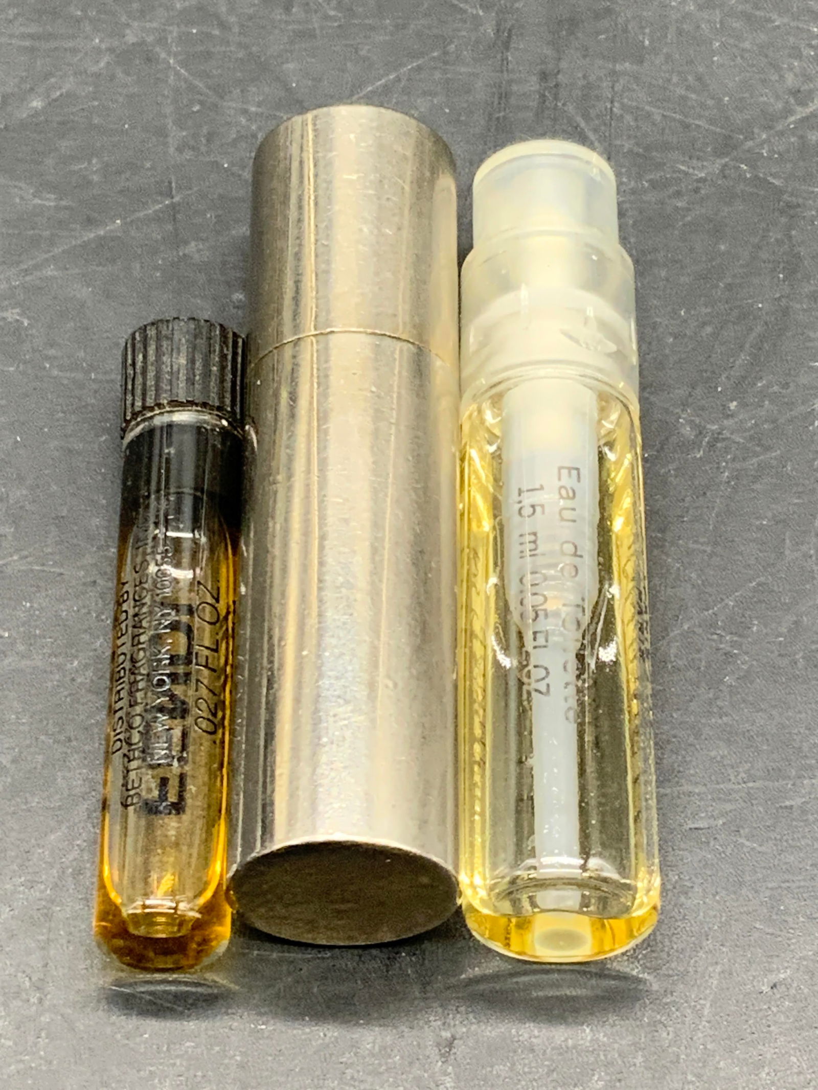 Lot 3 Perfume Samplers, FENDI, LANCOME & More: Three perfume samplers. Brands include FENDI, LANCOME & More. Pieces are crafted from glass, metal, or composite materials. Some liquid to interiors. Metal perfume sampler has a faceted crystal to the