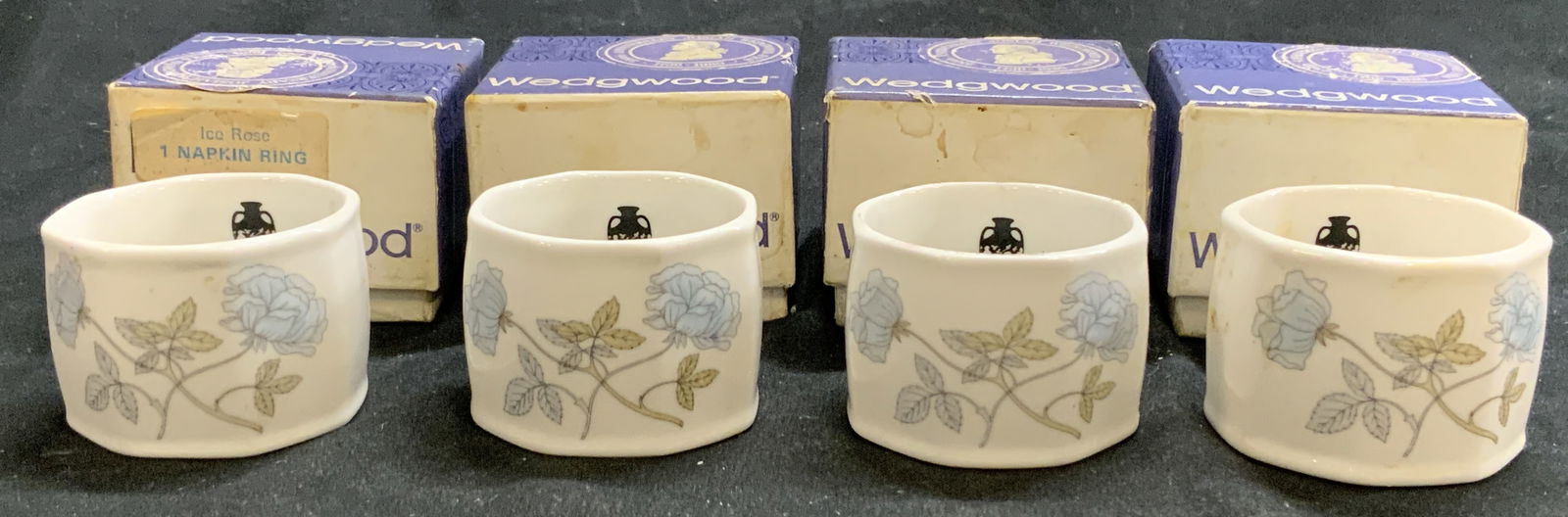 WEDGWOOD ICE ROSE 4 Porc Napkin Rings England, BX: Napkin rings are trademarked WEDGWOOD each read BONE CHINA MADE IN ENGLAND ICE ROSE. Lot includes 4 napkin rings, each with floral and leaf detail. Each napkin ring is porcelain. Napkin rings each inc