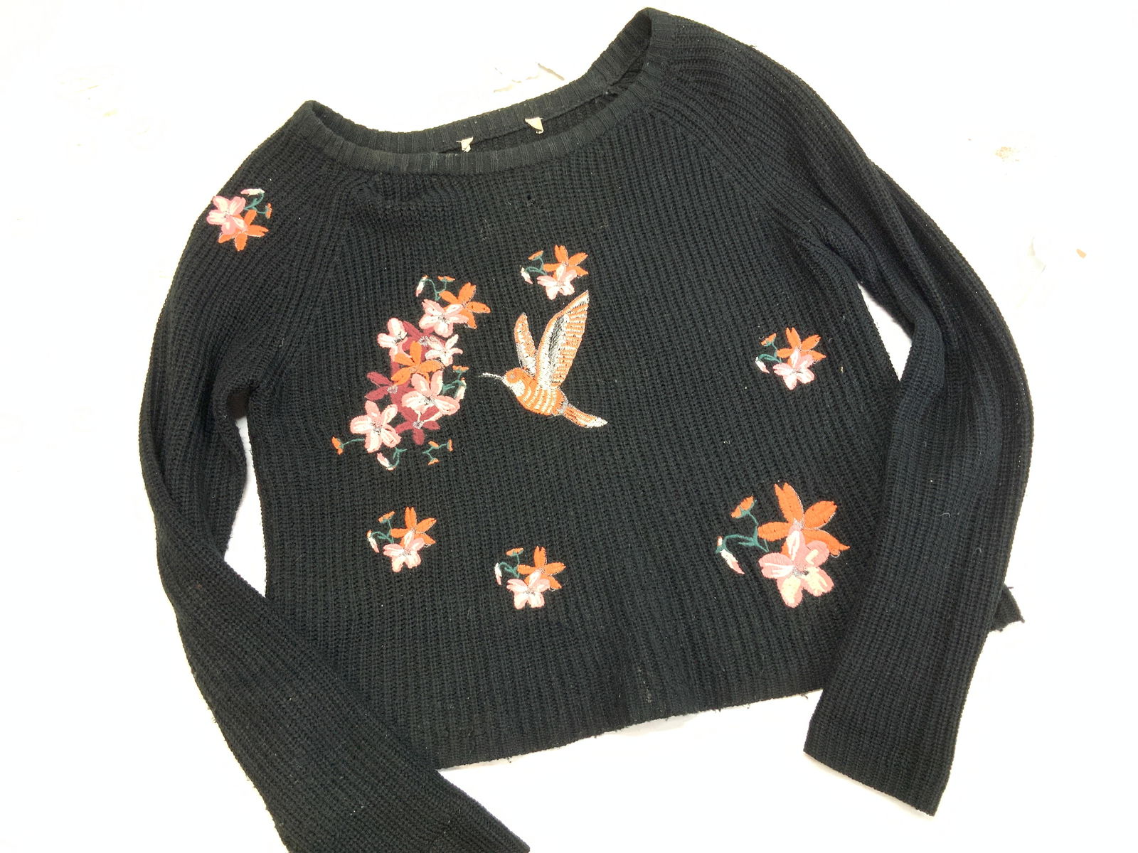 Applique Embroidered Hummingbird Sweater: Black acrylic sweater with tropical flowers and a hummingbird on front side- embroidered applique. Label has been removes. Measures 19.75 in. Long x 36 in. Wide. Hole on frontside. Knitwear, casual we