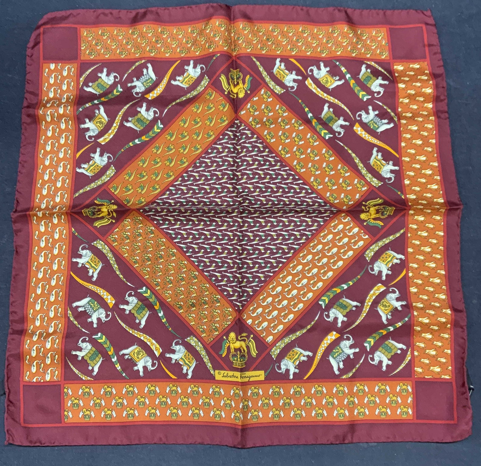 Salvatore Ferragamo Silk Elephant Handkerchief Ita: Salvatore FERRAGAMO red and orange elephant print handkerchief. 100% silk. Made in Italy. Signed on fabric and tag. Measures approx. 16.75 x 17 inches. Some wear to material consistent with exposure.