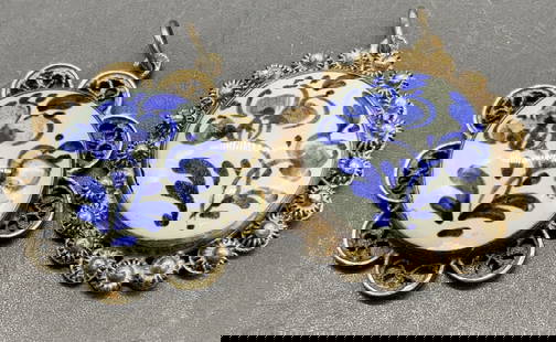2 DELFT Porcelain Filigree Metal Framed Pendants: Two vintage pendants. Delft porcelain cabochons framed by silver tone filigree metal. Blue and white floral motif to the porcelain. Reverse signed DELFT. Pieces are similar in size measuring