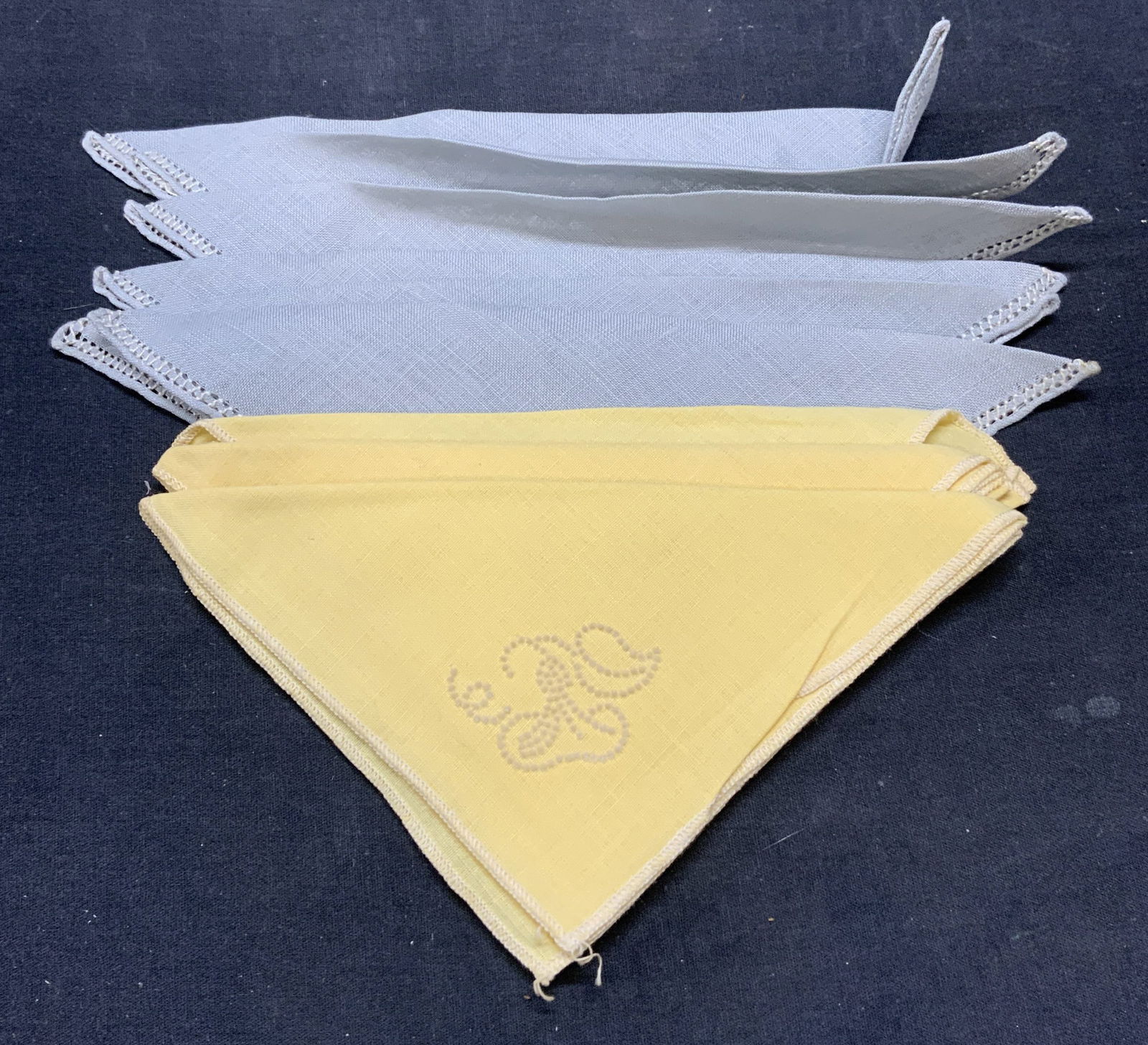 Group 9 Yellow & Blue Cotton Napkins: Group of 9 cotton cocktail napkins with embroidered decoration. 3 yellow and 6 blue. Largest napkins measure approx. 12 x 12 inches. All pieces have some wear to material consistent with exposure. Nap