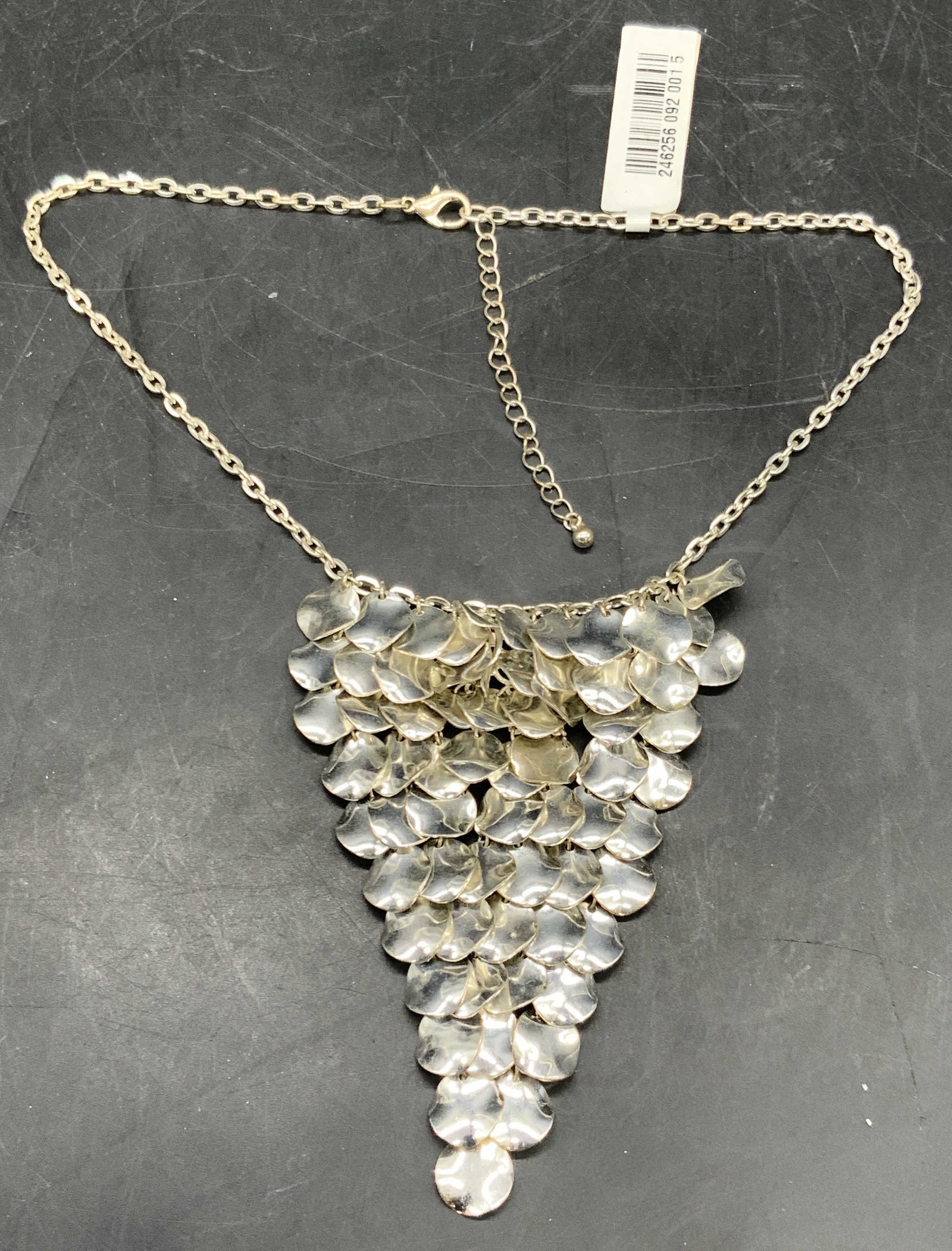 NWT Silver Tone Metal Bib Necklace, Jewelry: A silver tone metal bib necklace. Secures with a lobster claw clasp closure. Original tag attached. Adjustable length. Necklace length measured end to end approx. 21 inches. Some surface wear present.