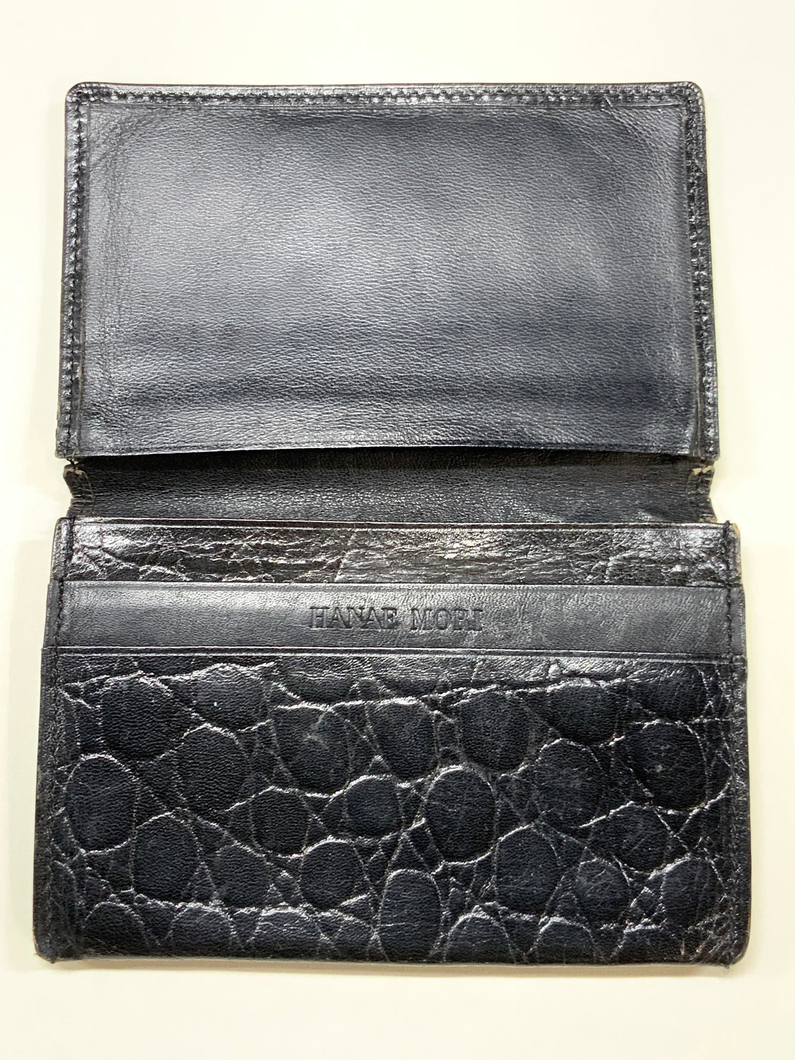 Hanae Mori Black Leather Card Wallet: Black leather card wallet with reptile textures on exterior. Marked Hanae Mori on interior, approx 4 x 3 inches Moderate wearing to edges of leather due to age and use Hanae Mori leather wallet, leath