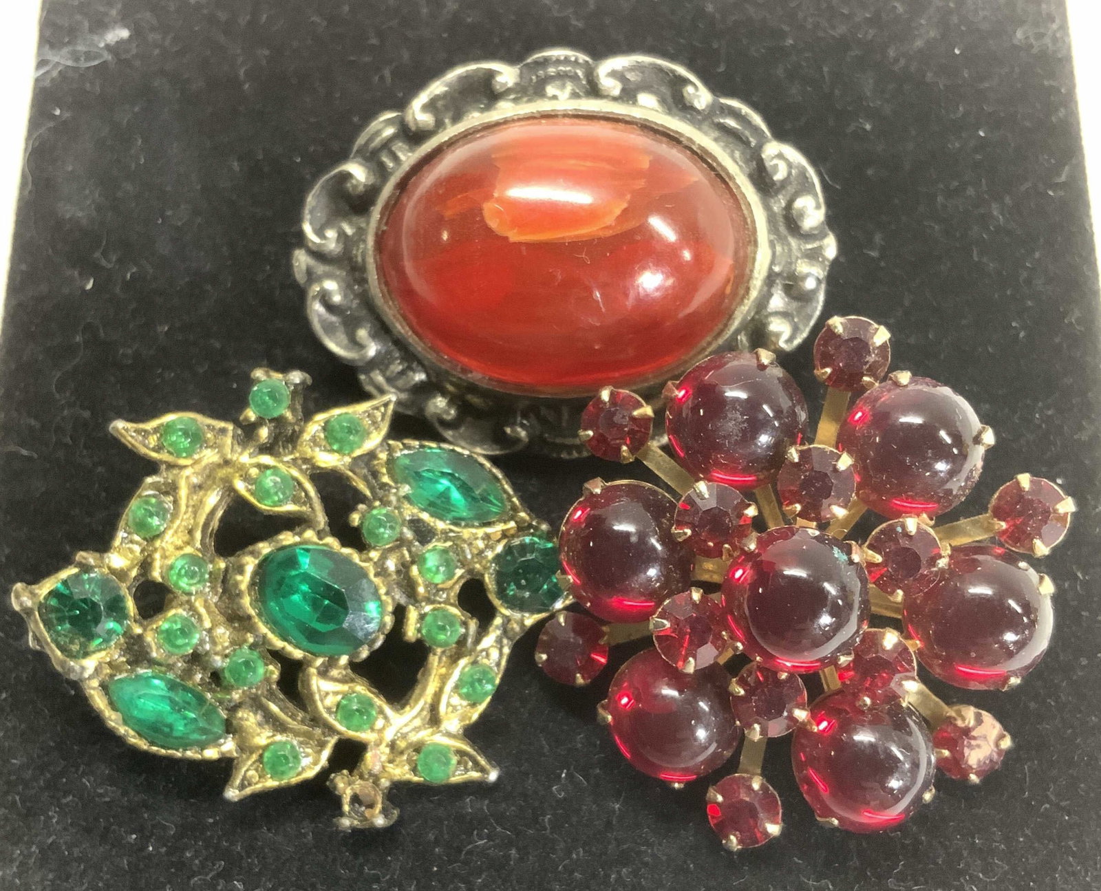 3 Vintage Crystal and Glass Pins, Jewelry: Bejeweled vintage brooches. art nouveau brooch with emerald crystals and gold tone.,1 x 1.25 in. Sputnik shape with red glass and red crystals , 1.25 in. Victorian style with center resin Cabochon in 