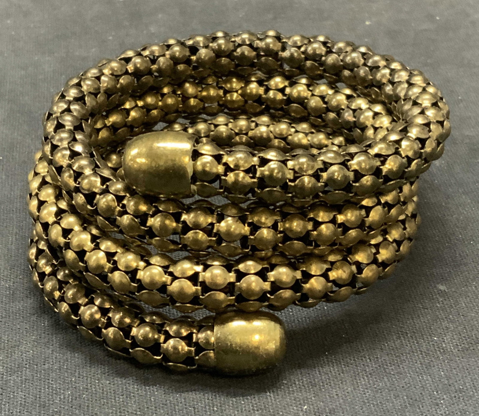 Gold Tone Mesh Chain Wrap Bracelet: Gold tone mesh chain wrap bracelet. Measures approx. 2.5 inches wide, adjustable width. Some surface wear including scratching observed. Estate jewelry, costume jewelry, cocktail jewelry, fashion jewe