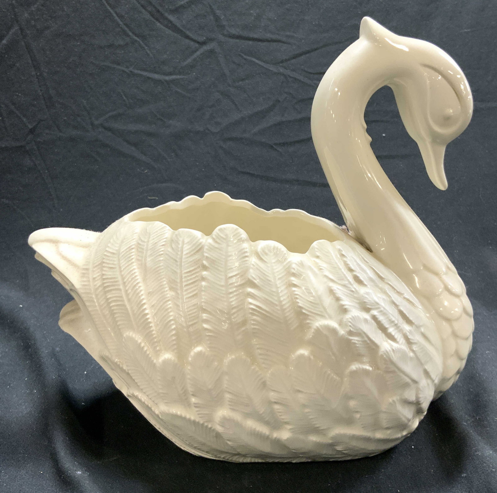 DOT Porcelain Swan Planter Vase Vessel: Underside inscribed DOT. Vessel is porcelain. Piece is cream toned. Appears to depict a seated swan. Piece has facial features and relief detail to show feathers. Piece measures approximately 8.5 inch