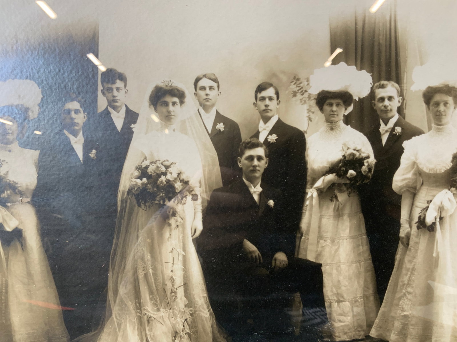 Antique Wedding Party Portrait Photograph: Subject depicts a wedding party posing for the camera during a wedding. Framed in gilt wooden frame. Frame measures approx. 22 W x 18 H in. Not viewed outside of frame. Wear consistent with age. Frami