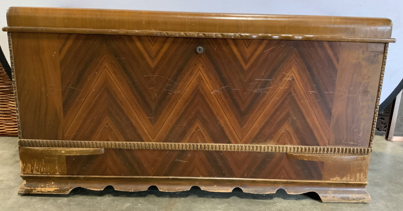 THE HONDERICH FURN Co Vntg Inlaid Wood Cedar Chest: Tag on interior reads THE HONDERICH FURNITURE CO. Chest is vintage. Piece is inlaid wood with carved pattern details in certain areas. Chest has hinged lid. Measures approx 48 inches long 25 inches ta