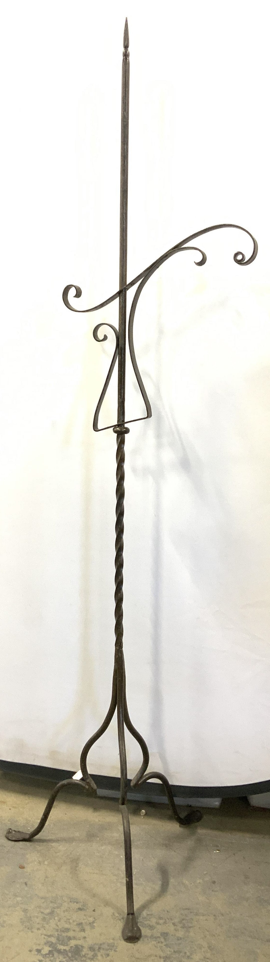 Iron Planter Stand, 62 in. Tall: 3 footed iron hanging flower basket stand, 62 in. Tall. Up cycle for hanging signs or other needs. Center scroll bar has a 360 degree swivel and measures 15 in. Wide. Base measures 16.5 in. Wide. Home