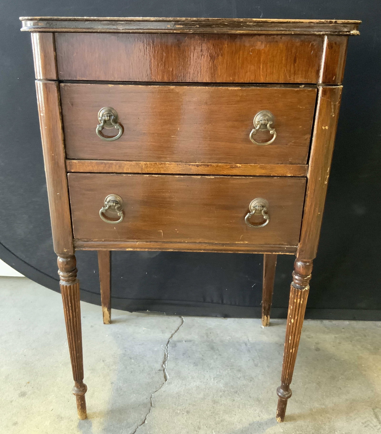 Antique Wooden Jewelry Chest W 2 Drawers: Jewelry chest is antique and wooden. Piece has 2 drawers each with dovetailing. Top of table has lid with various compartments. Each drawer has loop form gilt metal drawer pulls. Measures approx 26 in