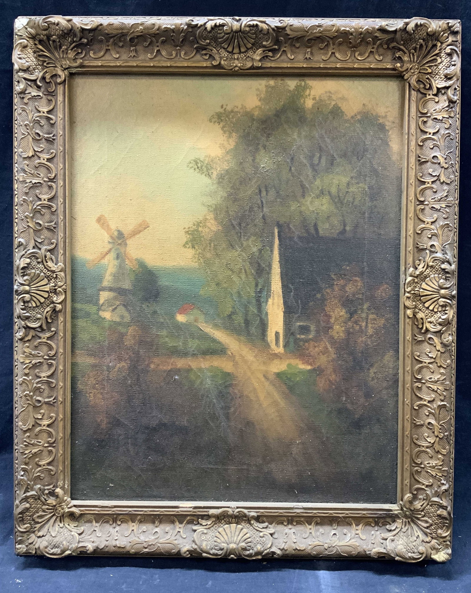 Framed Oil Painting New England Windmill: Oil paint on canvas. Subject depicts a farm house and a windmill across the street. Frames in gilt wooden frame with raised scrolling and patterned motifs. Frame measures approx. 18 W x 22.25 H in. Wi