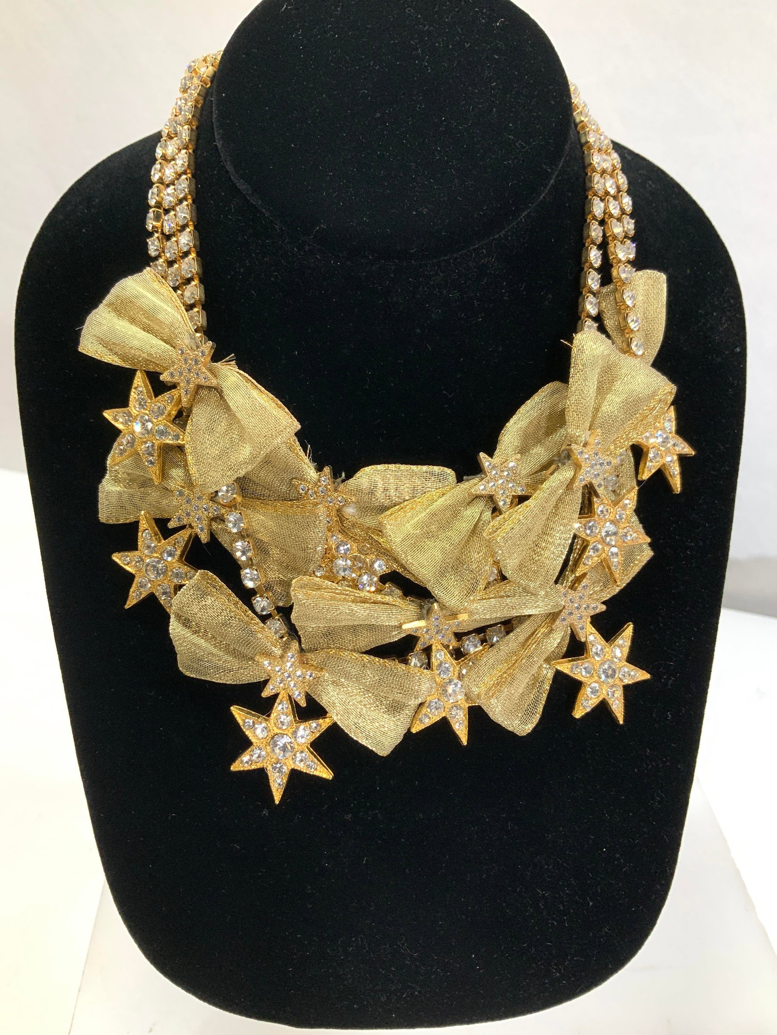 Crystal Star & Bow Choker Necklace, Jewelry: Luxury triple strand clear crystal necklace in gold tone . Enhanced with gold tone bows and gold tone and crystal starts. Attractive hook clasp. Decor is 2.25 in. Wide. Necklace drop is 5 in., Luxury 
