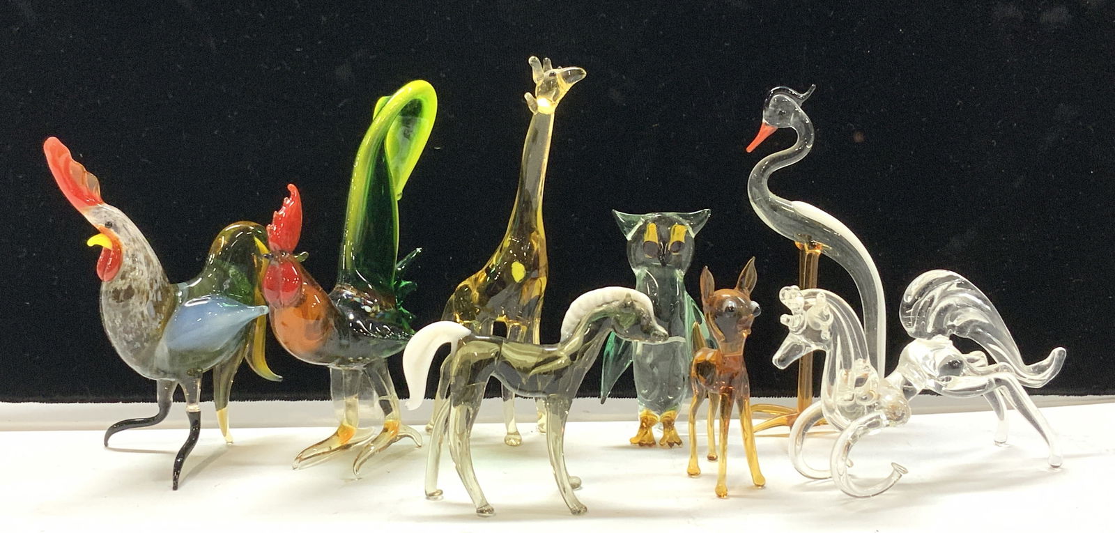 Blown Art Glass Animal Figurines, 8: Delicately hand blown art glass animal figurines. Roosters, Giraffe, Horse, deer, Owl, crane. Larger rooster measures 4 in. Tall x 3.5 in. Wide. Giraffe measures approximately 4.5 in. Tall. Some scrat