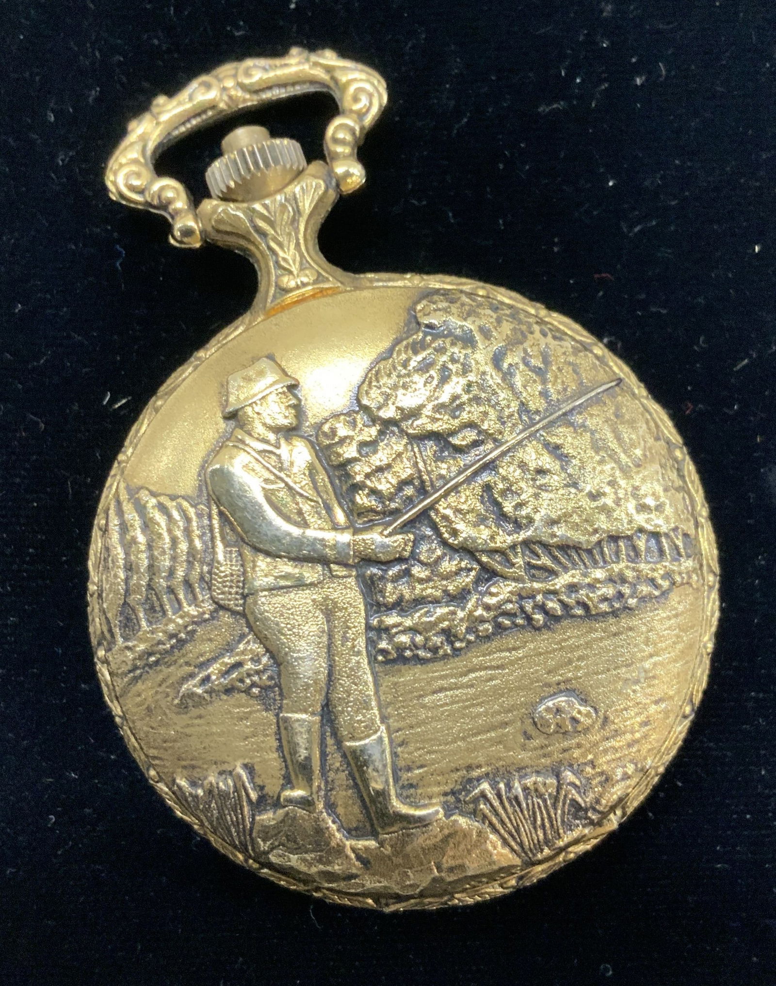 Majestron Ornate Gold Toned Pocket Watch: Quartz movement MAJESTRON pocket watch. Gold tone metal with embossed design of a man fishing . Roman numeral numbers. Measures 1.75 in. Diameter . 2.75 in. Long. Pocket watch, fob watch, Majestron Qu