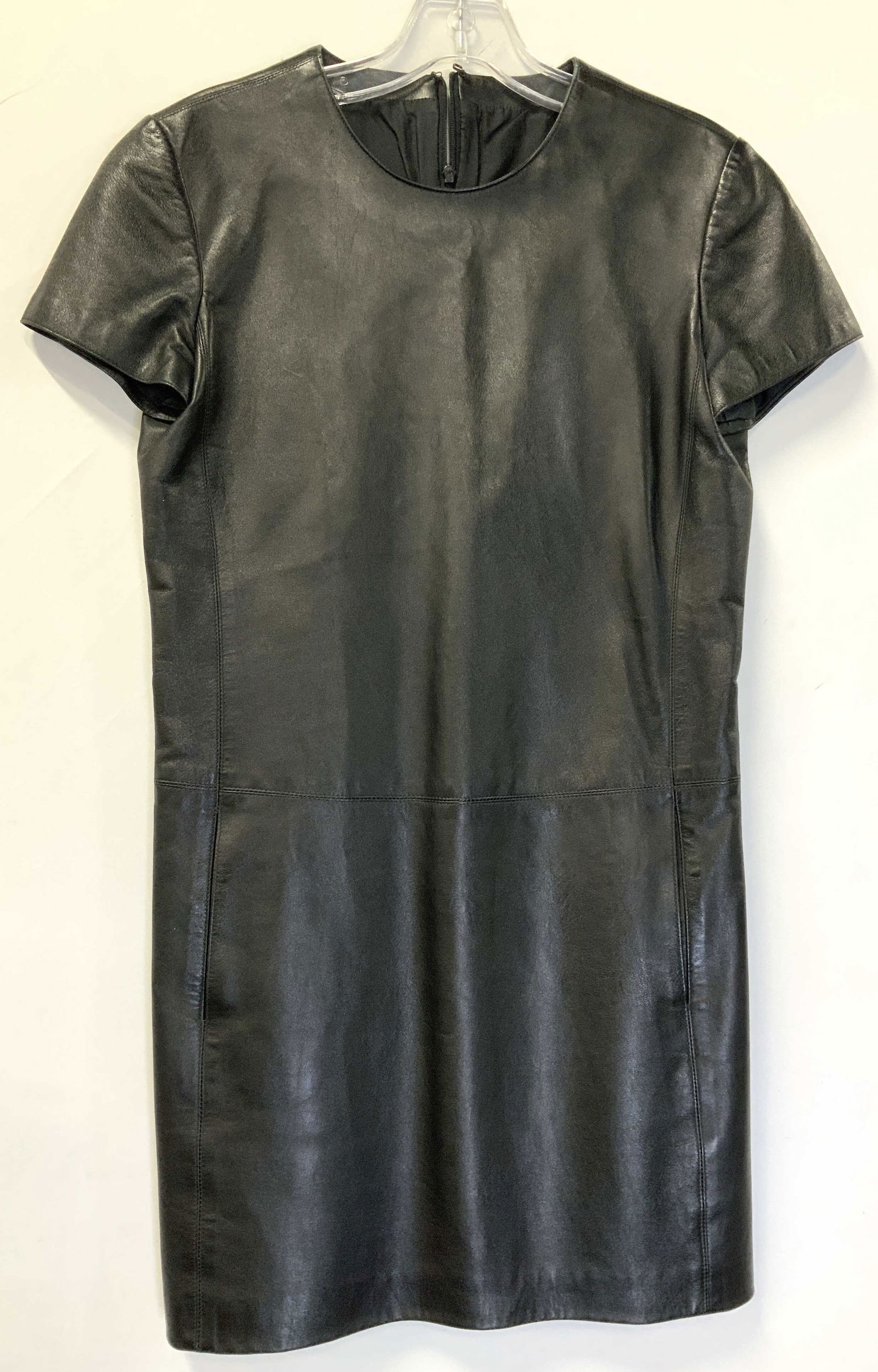 Black Leather Dress w Hand Pockets: Short sleeve black leather dress. Silk lined. Backside zipper and hook at neck. Measures 30.5 in. Long , 30 in. Waist. Has hand pockets. Supple, smooth, soft hand leather. No design labels. Little bla