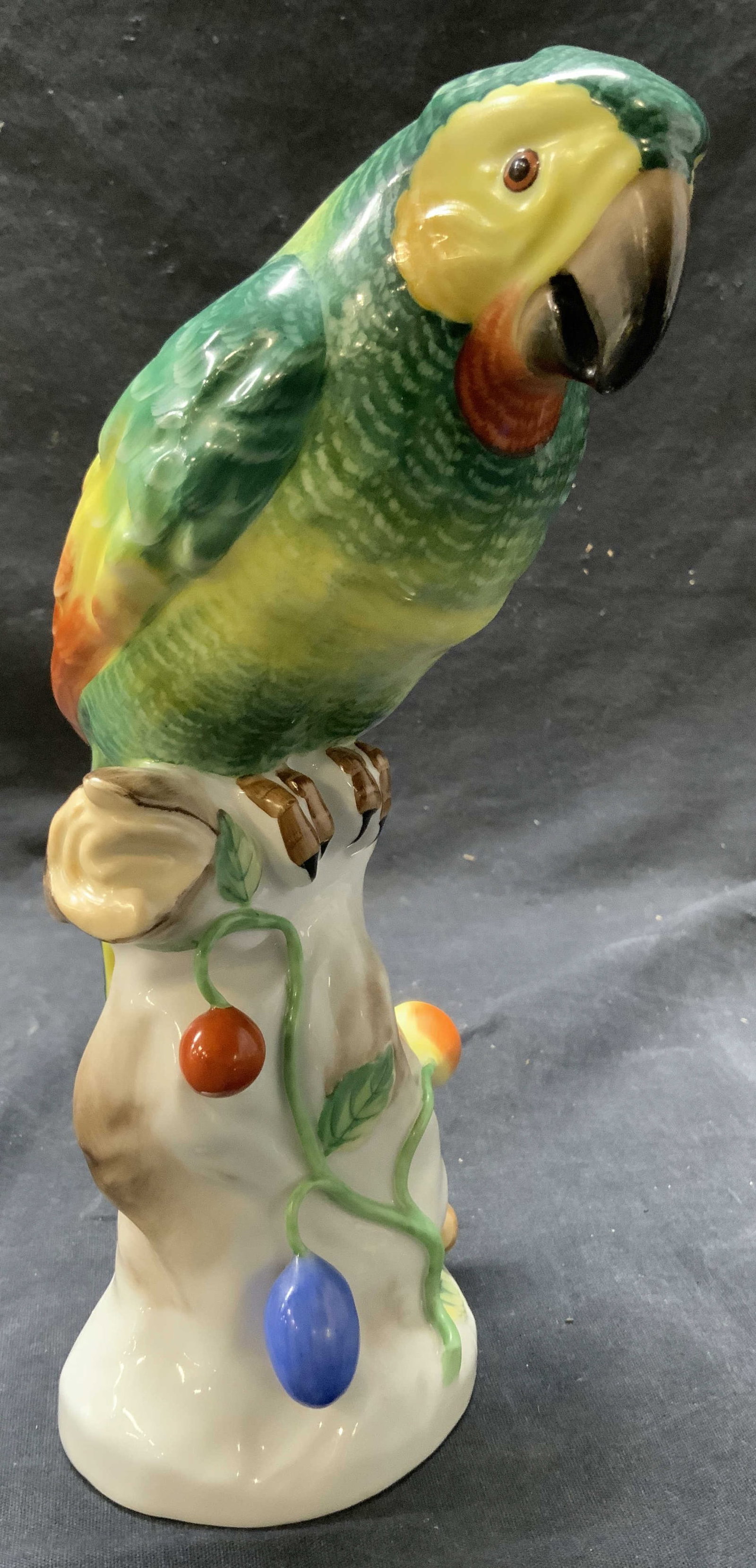 HEREND Vntg Porcelain Parrot Figure: Underside reads HEREND HUNGARIA. Figure is vintage and porcelain. Piece depicts a Parrot figure perched on a branch. Piece also has floral fruit, vine & leaf detail. Piece is possibly hand painted. Me