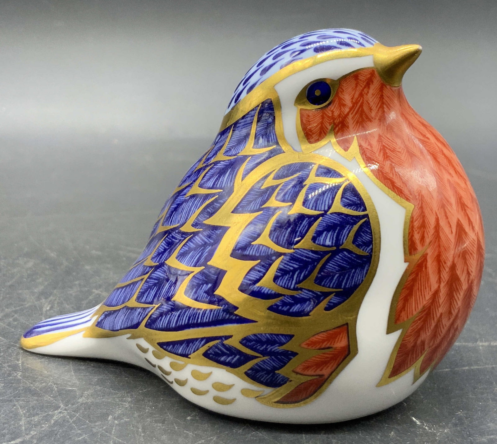 Royal Crown Derby English Porcelain Bird Figural: A vintage Royal Crown Derby English porcelain bird figural in traditional Imari colors with gilt line work. Gold tone button to the underside. Measures approx. 3H x 3.5W in. Underside signed ROYAL CRO