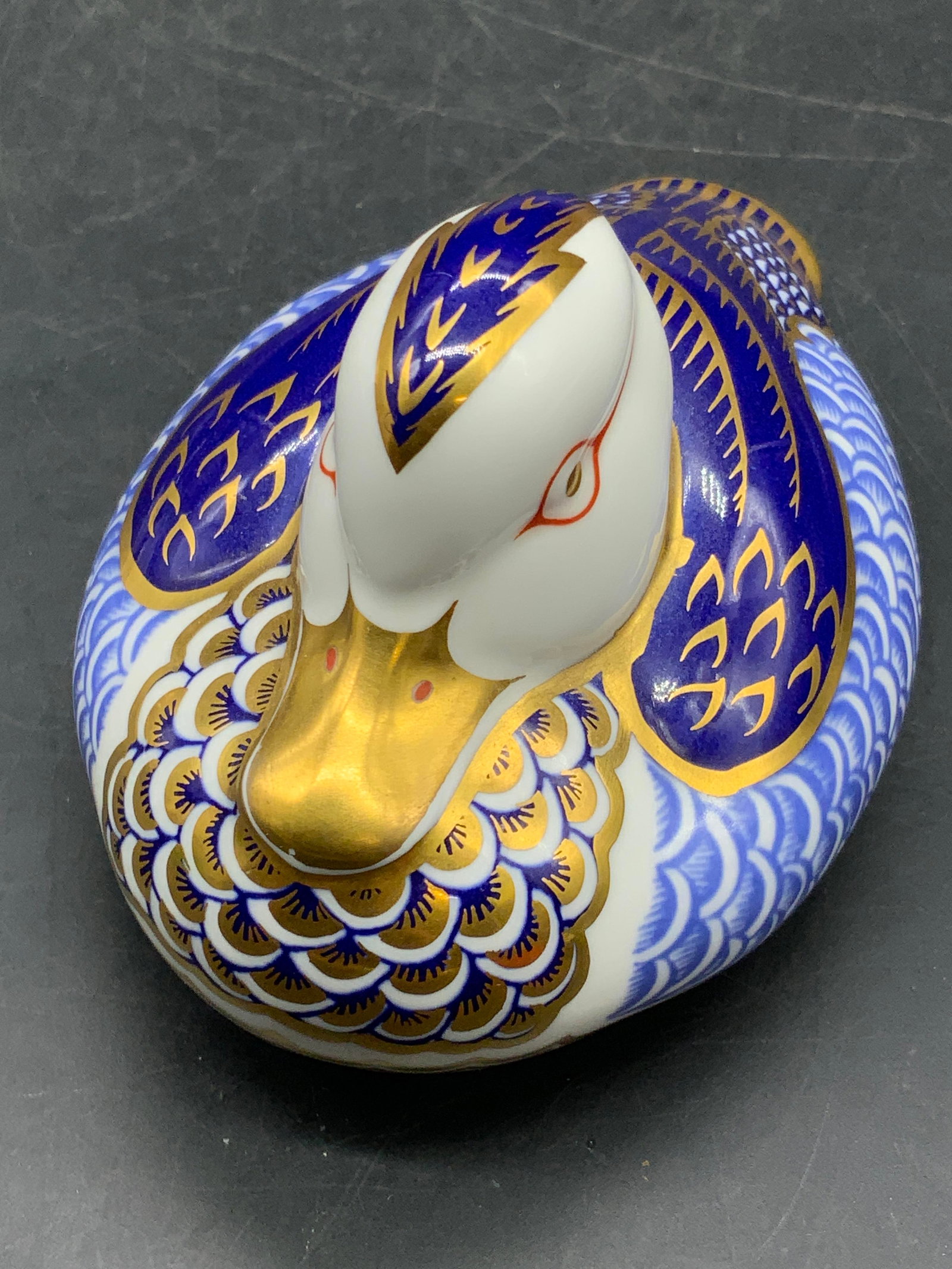 Royal Crown Derby English Porcelain Duck Figural: A vintage Royal Crown Derby English porcelain duck figural in traditional Imari colors with gilt line work. Gold tone button to the underside. Measures approx. 3H x 4.5W in. Underside signed ROYAL CRO