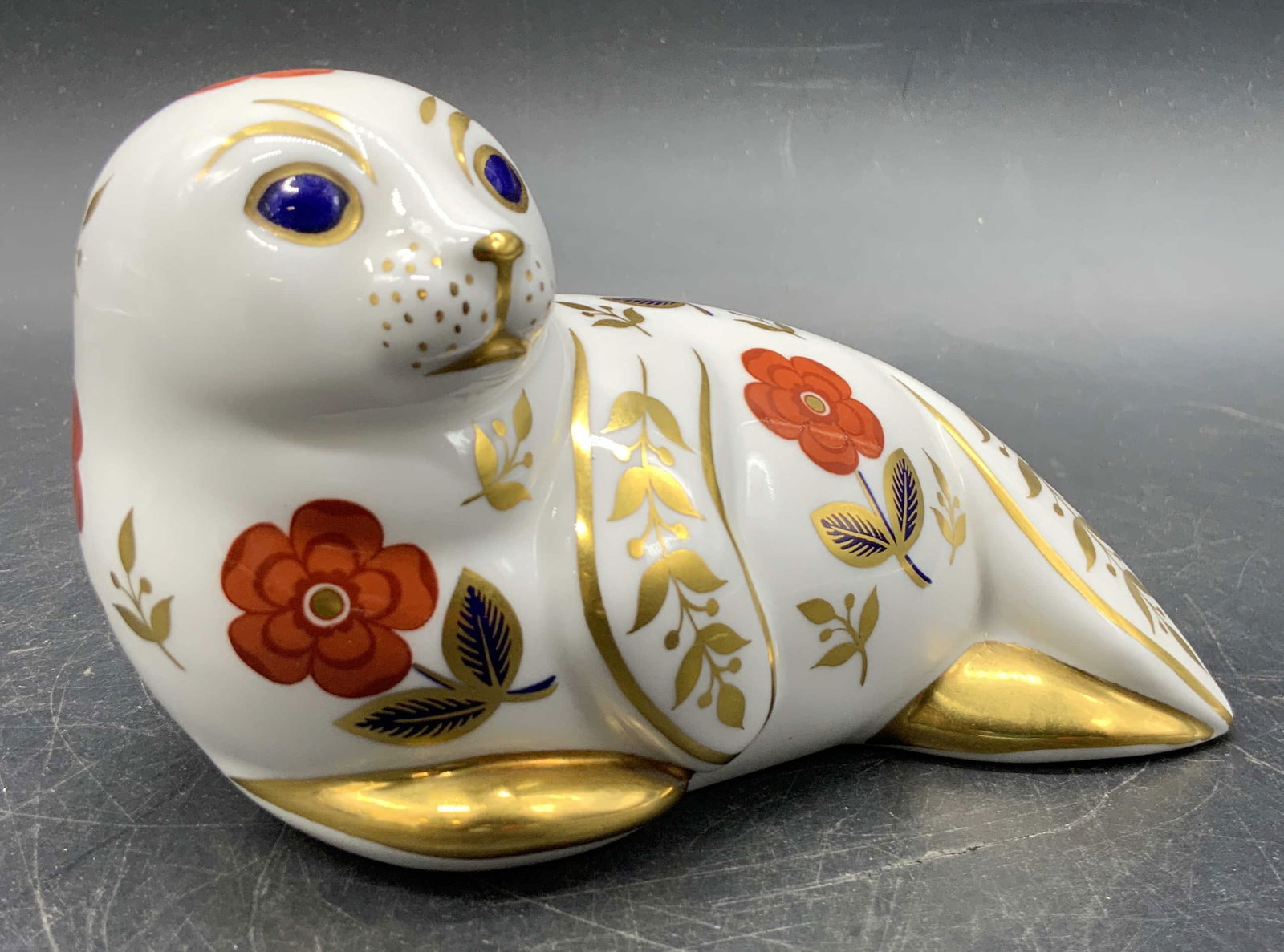 Royal Crown Derby English Porcelain Seal Figural: A vintage Royal Crown Derby English porcelain seal figural in traditional Imari colors with gilt line work. Measures approx. 3H x 5W in. Underside signed ROYAL CROWN DERBY, ENGLISH BONE CHINA, XLIX. D